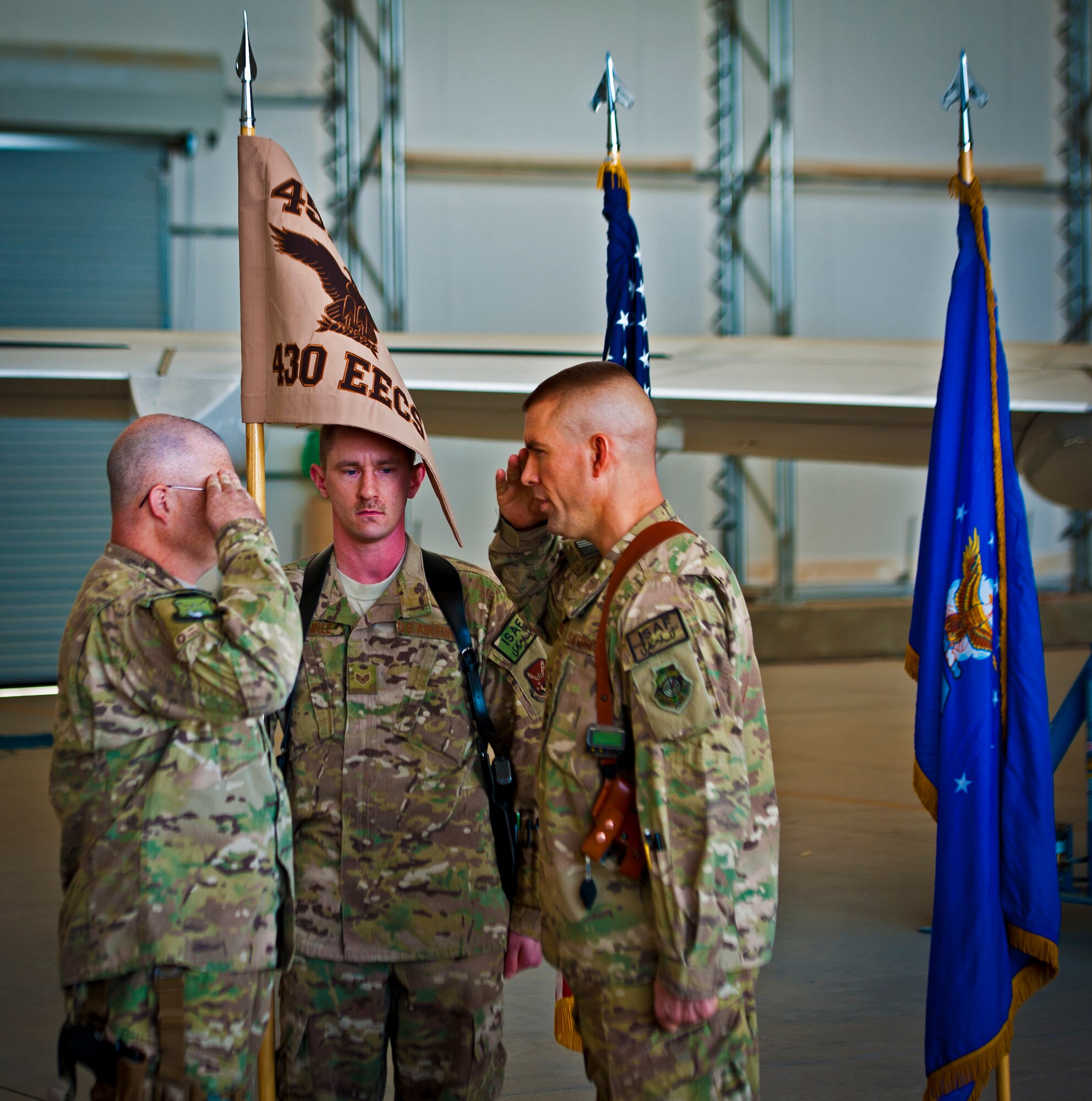 Chief Master Sgt. James Isom, 451st Expeditionary Operations Group superintendent, renders a salute to Col. Brook Leonard, 451st EOG commander, during an activation ceremony for the 430th Expeditionary Electronic Combat Squadron, at Kandahar Airfield, March 13, 2013. The unit, which flies the E-11A, was previously designated as the 451st Tactical Airborne Gateway. (U.S. Air Force photo/Senior Airman Scott Saldukas)