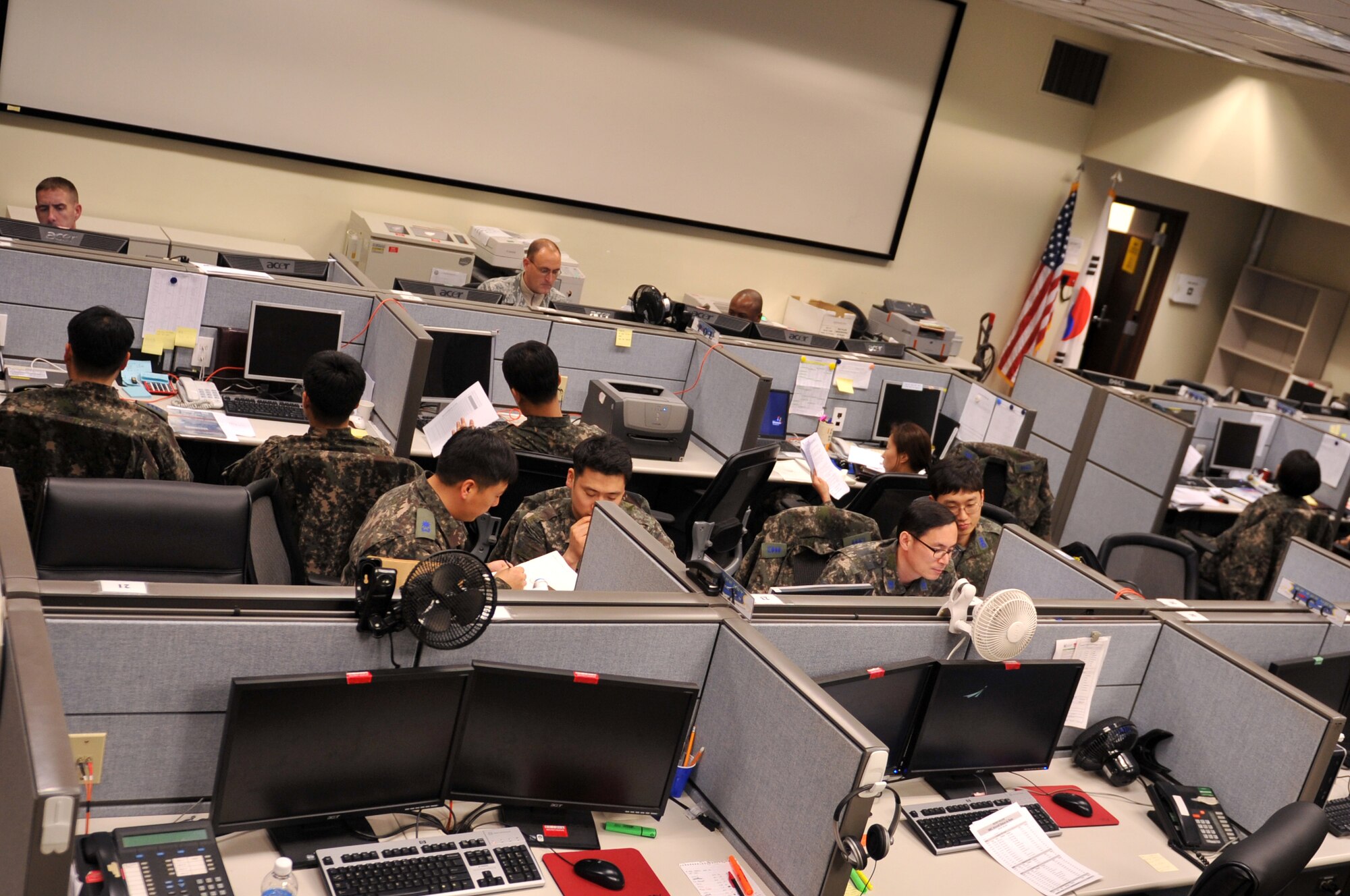 U.S. Air Force logistics Airmen and Republic of Korea Air Force personnel converse at the Combined Air Logistics Center during Exercise Key Resolve on Osan Air Base, Republic of Korea, March 15, 2013. The CALC manages the distribution of the Air Component Commands resources, and has an essential role in Key Resolve because logistics helps the command successfully execute the air campaign through logistics planning, coordination and execution command and control. (U.S. Air Force photo/Airman 1st Class Hailey R. Davis)