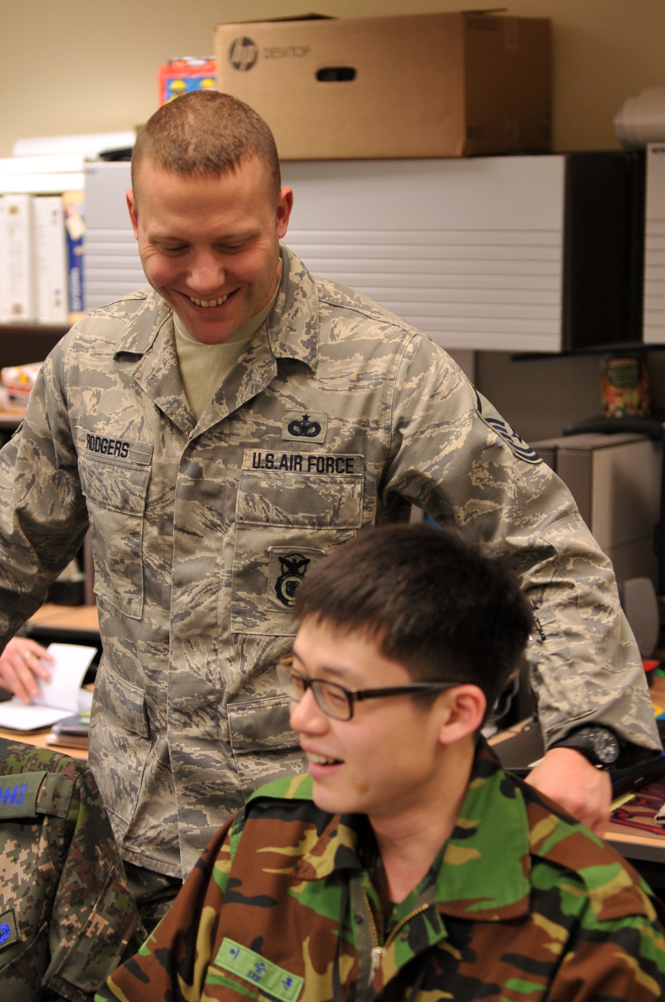 U.S. Air Force Air National Guard Master Sgt. Thomas Rodgers, 7th Air Force Air Component Command force protection cell NCO, speaks with Republic of Korea Air Force Staff Sgt. Lee, Seung Hun, 7th Air Force ACC interpreter, during Exercise Key Resolve on Osan Air Base, Republic of Korea, March 15, 2013. Although this is the first year that the ROK Joint Chiefs of Staff has taken the lead to plan and execute KR, the U.S. will conduct the air campaign with our ROK counterparts. This teamwork will improve ROK command and control capabilities and establish a basis for the transfer of operational control to the ROK JCS in 2015. (U.S. Air Force photo/Airman 1st Class Hailey R. Davis)