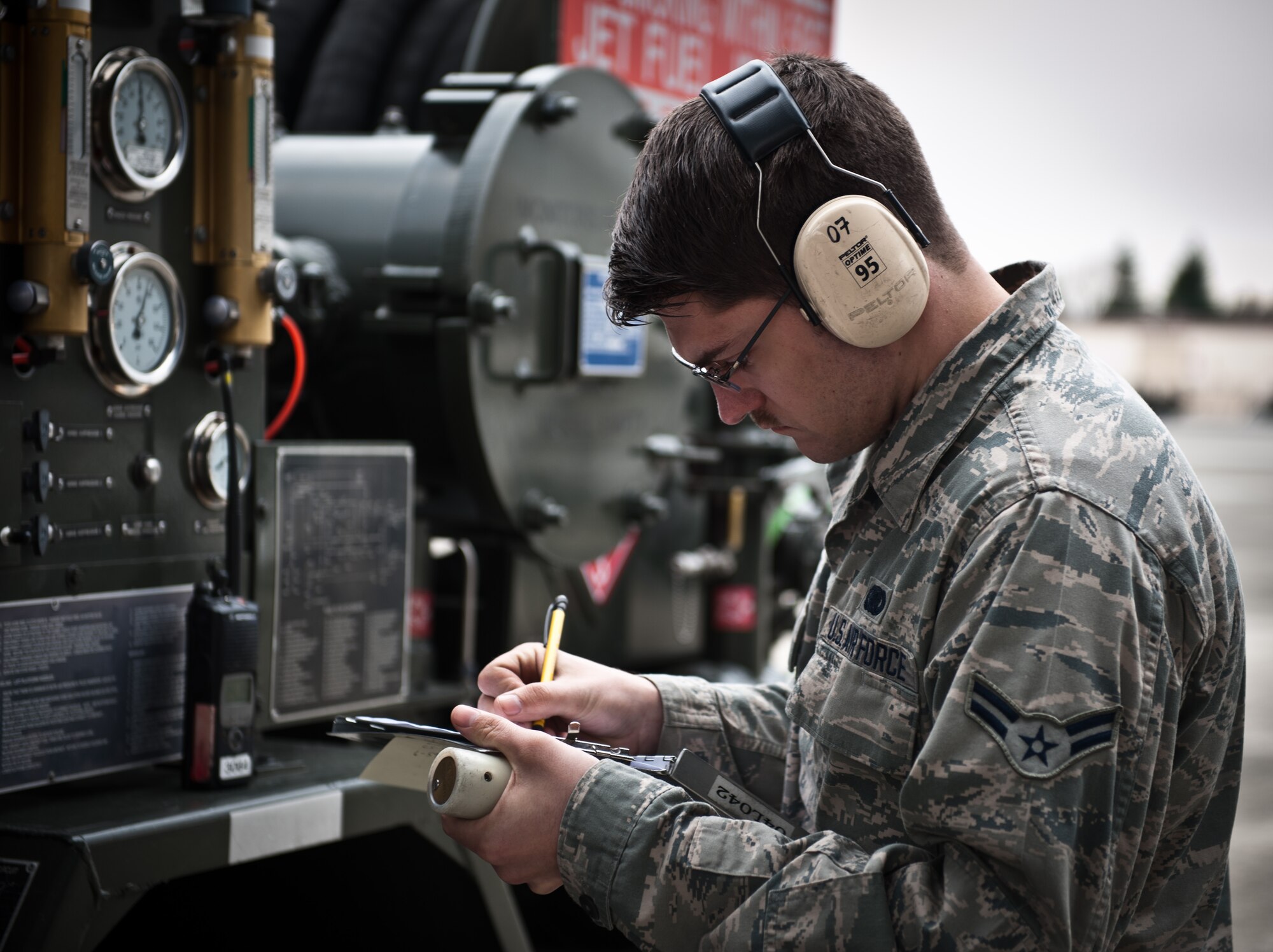 YOKOTA AIR BASE, Japan -- Airman 1st Class Trevor Kling, 374th Logistics Readiness Squadron fuels distribution operator, monitors the fuel intake of a contracted civilian airliner from his R-12 refueling truck at Yokota Air Base, Japan, March 14, 2013. When three large civilian aircraft were diverted to Yokota March 13 due to high winds, the fuels distribution team provided more than 12,000 gallons of fuel on short notice to get the planes back in the air. (U.S. Air Force photo by 1st Lt. Christopher Love) 
