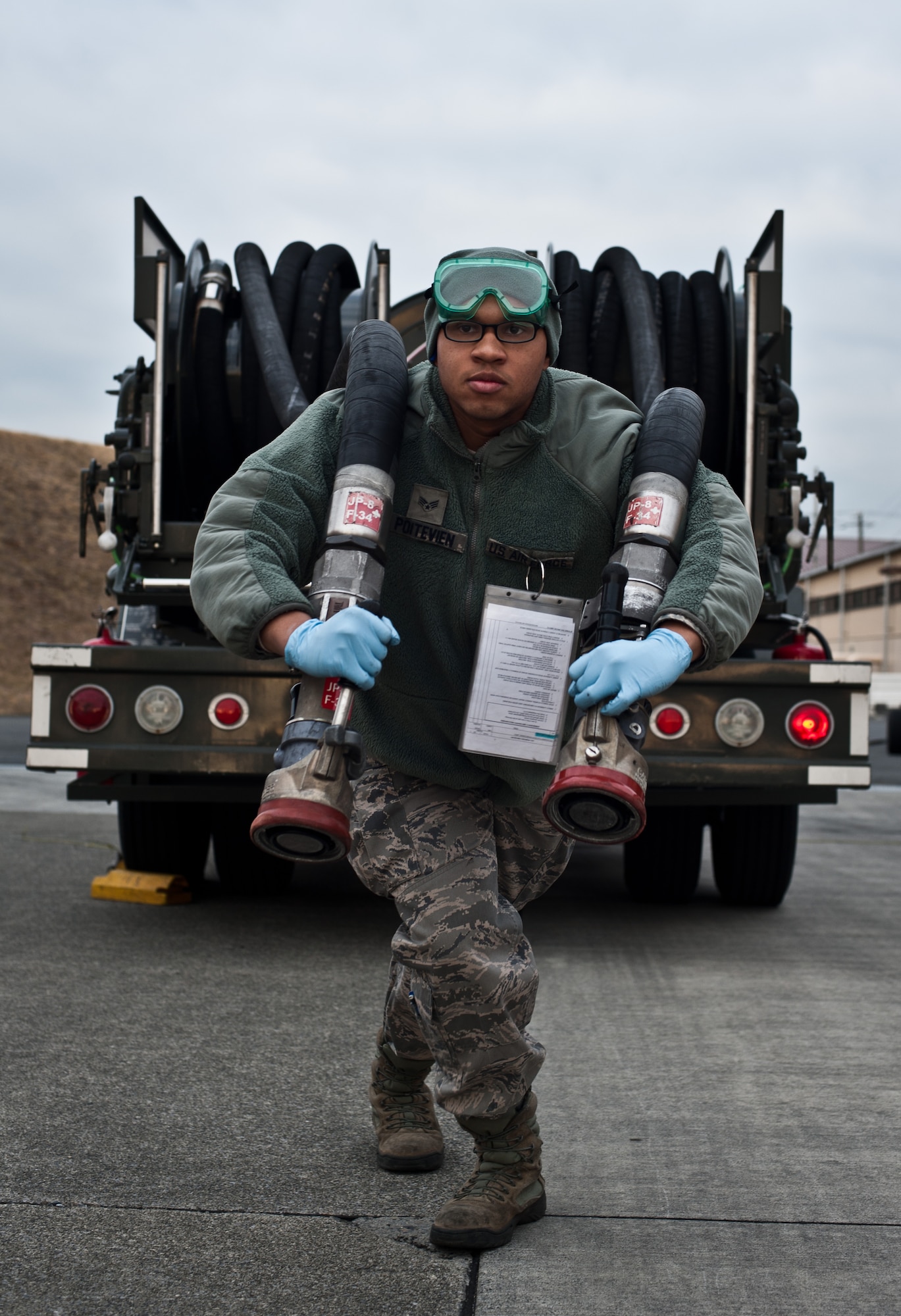 YOKOTA AIR BASE, Japan -- Senior Airman Michael Poiteview, 374th Logistics Readiness Squadron preventative maintenance technician and a Long Island, NY native, unravels fuel hoses from an R-12 refueling truck at Yokota Air Base, Japan, March 15, 2013. Pointeview and his team keep trucks safe and ready to refuel aircraft on short notice. (U.S. Air Force photo by 1st Lt. Christopher Love) 