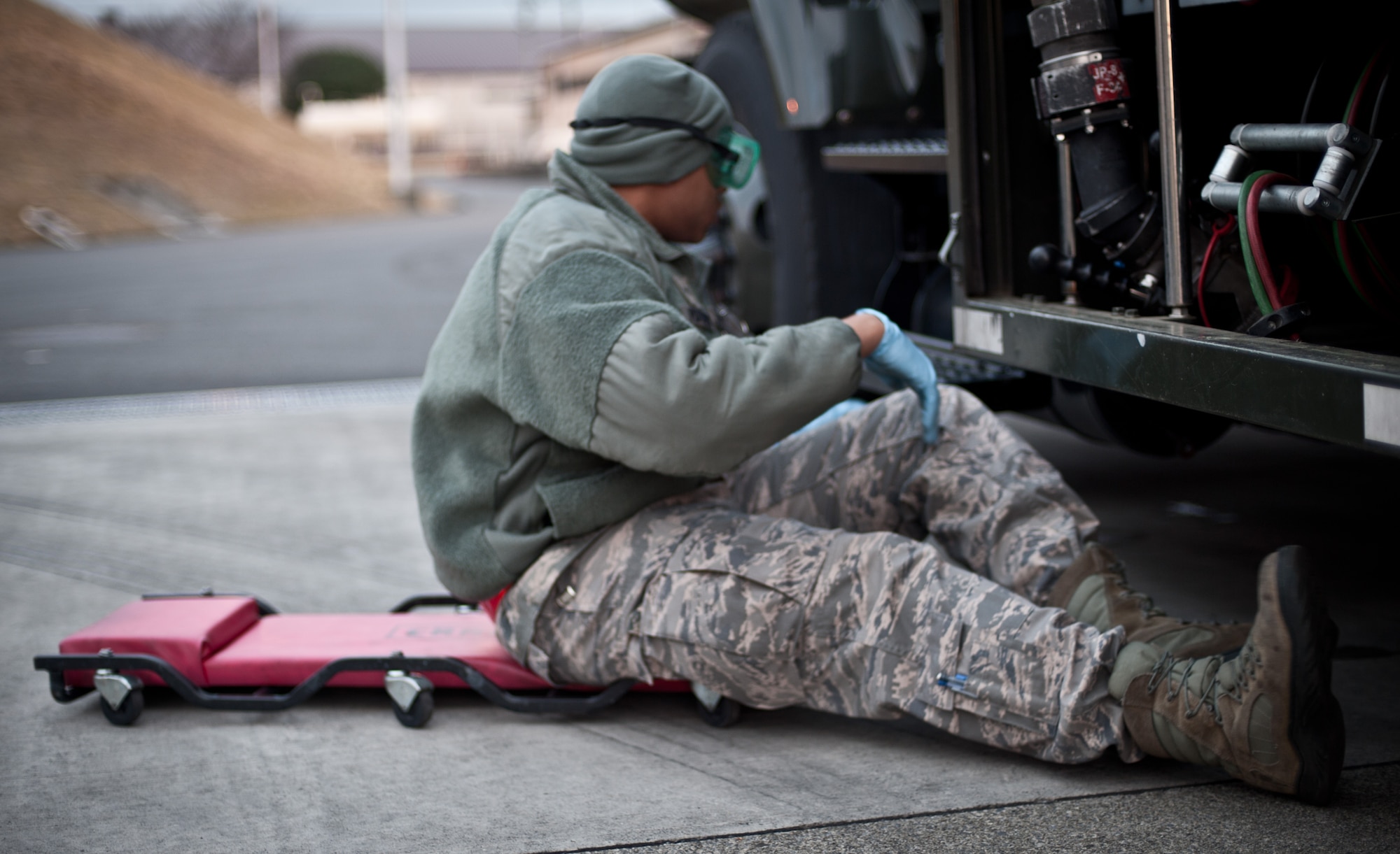 YOKOTA AIR BASE, Japan -- Senior Airman Michael Poiteview, 374th Logistics Readiness Squadron preventative maintenance technician, inspects an R-11 refueling truck for leaks and other issues at Yokota Air Base, Japan, March 15, 2013. The preventative maintenance team conducts daily check-ups to preserve the health of the refueling fleet. (U.S. Air Force photo by 1st Lt. Christopher Love) 