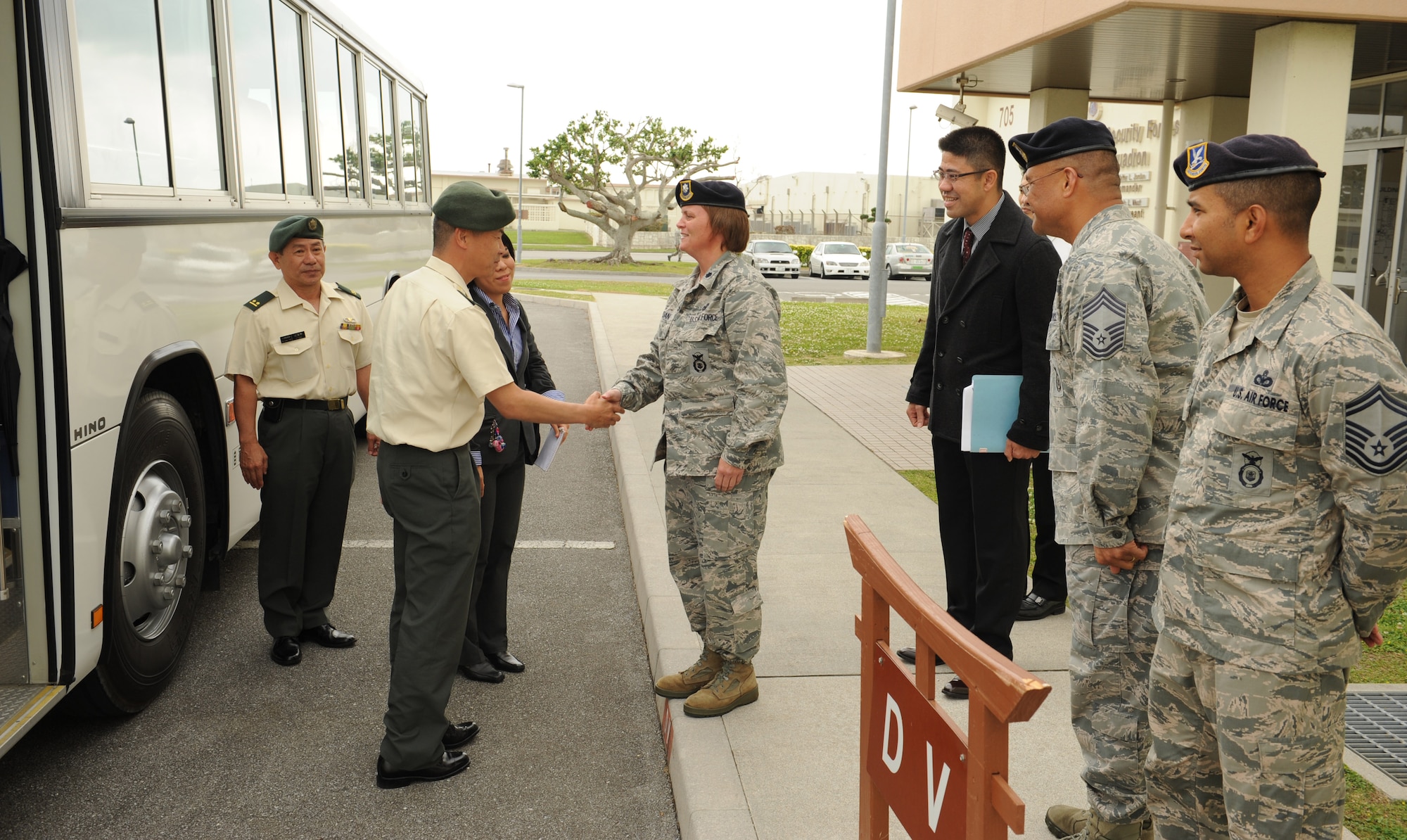 Japan Ground Self Defense Force Maj. Gen. Tomofusa Harada, Western Army deputy chief of staff, shakes hands with U.S. Air Force Lt. Col. Kathy Jordan, 18th Security Forces Squadron commander, on Kadena Air Base, Japan, March 14, 2013. Harada and Japanese civic leaders toured the security forces squadron facility to learn more about the 18th SFS mission after a courtesy call with Brig. Gen. Matt Molloy, 18th Wing commander. (U.S. Air Force photo/Airman 1st Class Keith A. James)