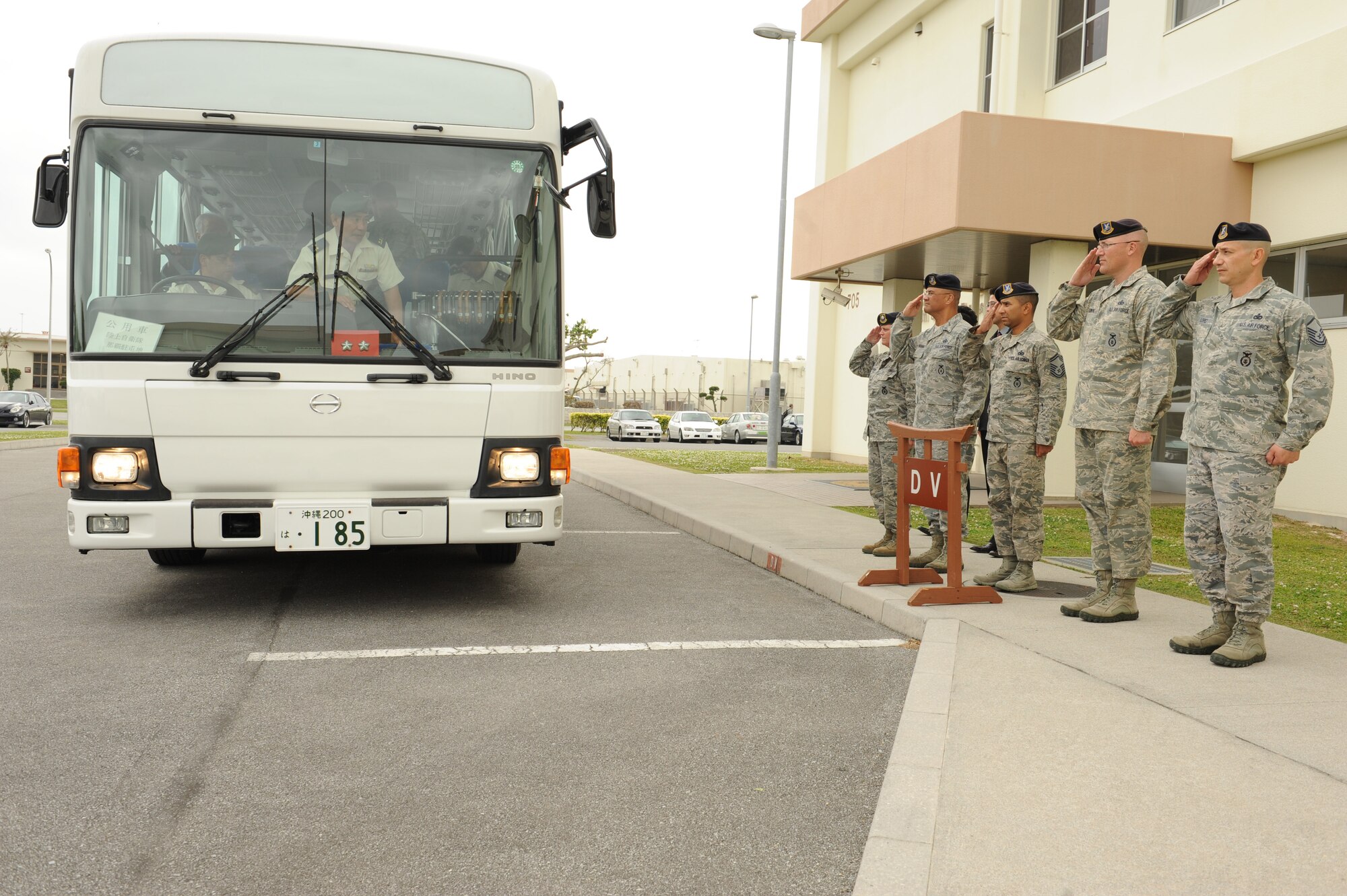 Members of the 18th Security Forces Squadron salute as Japan Ground Self Defense Force Maj. Gen. Tomofusa Harada, Western Army deputy chief of staff, arrives on Kadena Air Base, Japan, March 14, 2013. Harada and Japanese civic leaders arrived to tour the 18th SFS facility to learn more about its mission. (U.S. Air Force photo/Airman 1st Class Keith A. James)