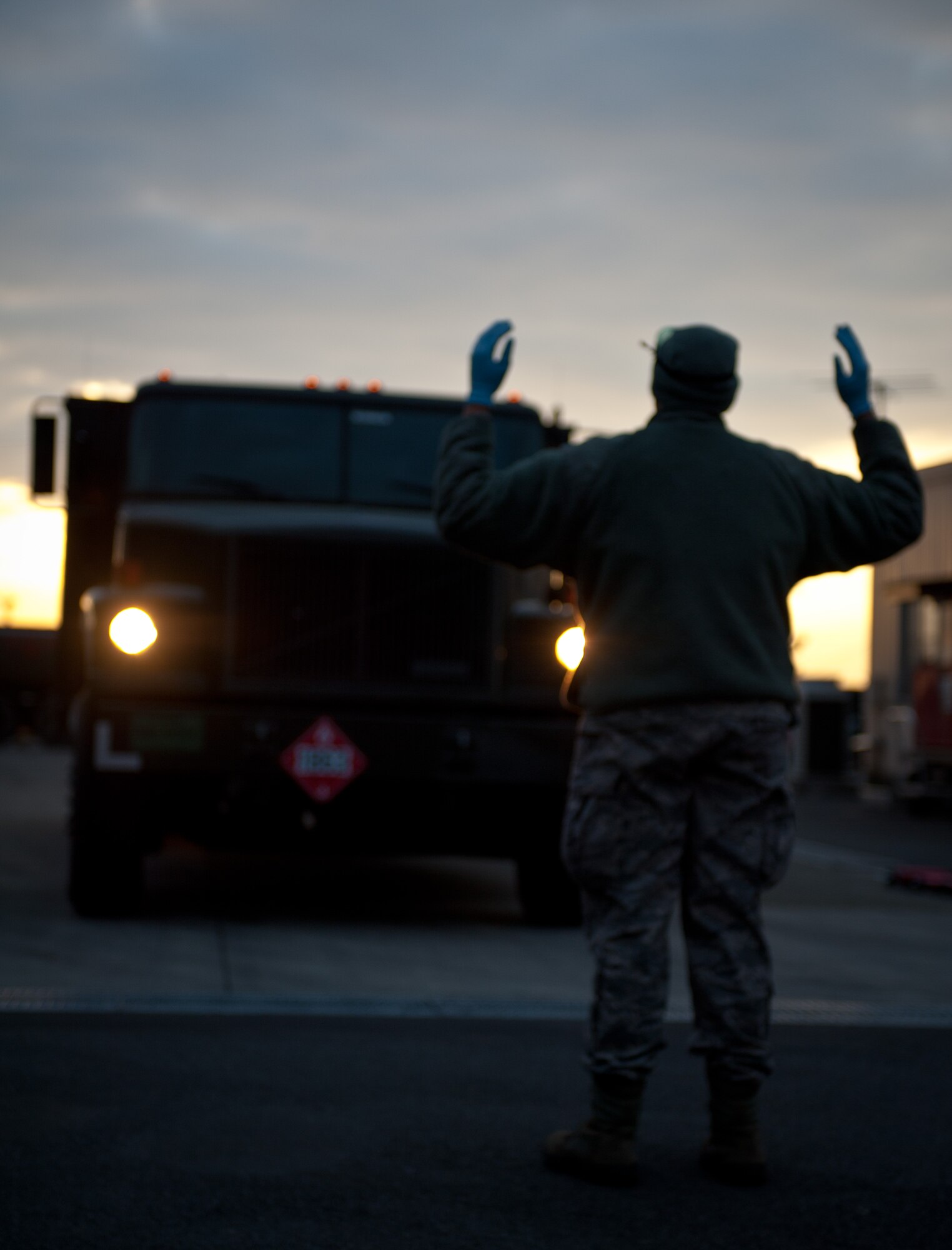 YOKOTA AIR BASE, Japan -- Senior Airman Michael Poiteview, 374th Logistics Readiness Squadron preventative maintenance technician, signals the driver of an R-11 refueling truck into position for an inspection at Yokota Air Base, Japan, March 15, 2013. The preventative maintenance team arrives to work at 5 a.m. each day to check the readiness of a fleet of refueling trucks. (U.S. Air Force photo by 1st Lt. Christopher Love) 