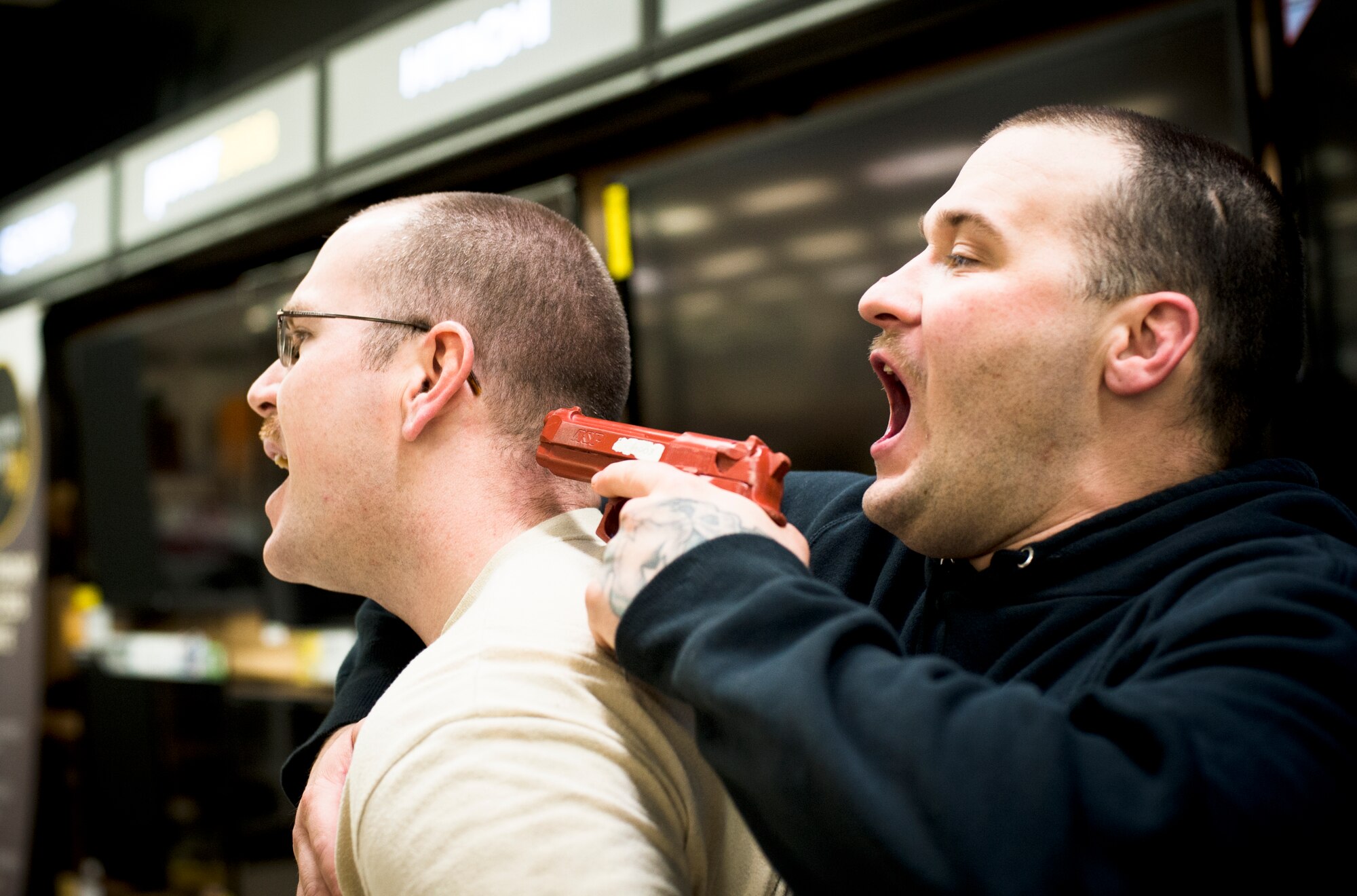 YOKOTA AIR BASE, Japan -- A simulated active shooter shouts for security and threatens a simulated hostage during an active shooter training scenario March 15, 2013, at Yokota Air Base, Japan. The training helped prepare 20 members of the 374th Security Forces Squadron on active-shooter response and other security-arms techniques. (U.S. Air Force photo by Senior Airman Cody H. Ramirez)