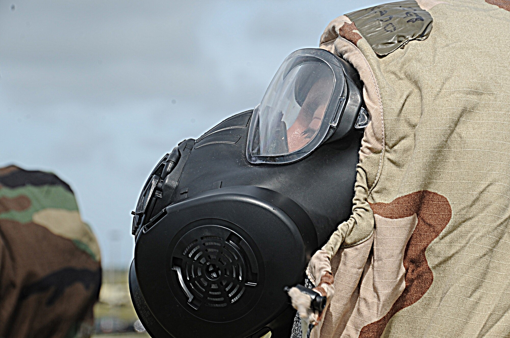 Tech Sgt. Luis Alvarado, 36th Civil Engineer Squadron water and fuels systems operator, gears up during the Ability to Survive and Operate training on Andersen Air Force Base, Guam, March 15, 2013. The training ranged from decontamination, transition points, chemical gear wear check, self-aid and buddy care, unexploded ordnance identification, land-mobile radio, and also M-16 assembly training. (U.S. Air Force photo by Airman 1st Class Adarius Petty/Released)