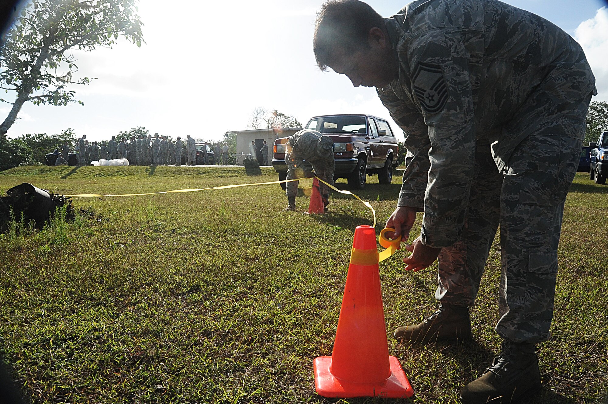Senior Master Sgt. Matthew Messner, 734th Air Mobility Squadron Aerial Port superintendent, cordons off an area during a chemical, biological, radiological, nuclear and high-yield explosives class on Andersen Air Force Base, Guam, March 7, 2013. CBRNE training is conducted regularly for Airmen to maintain readiness for deployment procedures.  (U.S. Air Force photo by Airman 1st Class Adarius Petty/Released)