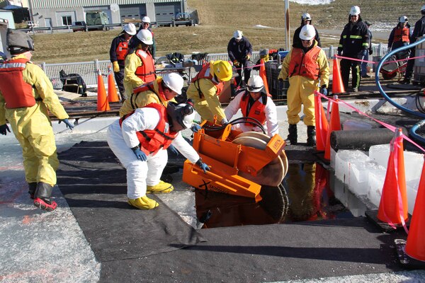 Arctic oil spill responders place a mechanical skimmer used for oil recovery during their recent training with Alaska Clean Seas instructors, hosted at ERDC-CRREL.