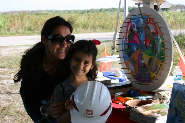 Everglades Day at the Arthur R. Marshall Loxahatchee National Wildlife Refuge brings many families and children like Sara Green to the Corps booth, where they spin the “Wayne Drop” wheel and learn about the Everglades and water safety. 