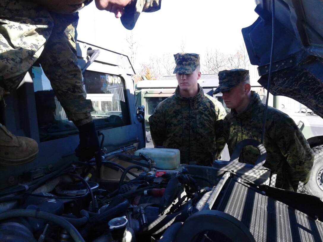 Sgt Purington instructing PFC Meade and PFC Metts on proper PMCS of a HMMWV (M1165) at the 58th Trans Motor Pool, Ft. Leonard Wood, Mo. during MVOC training.