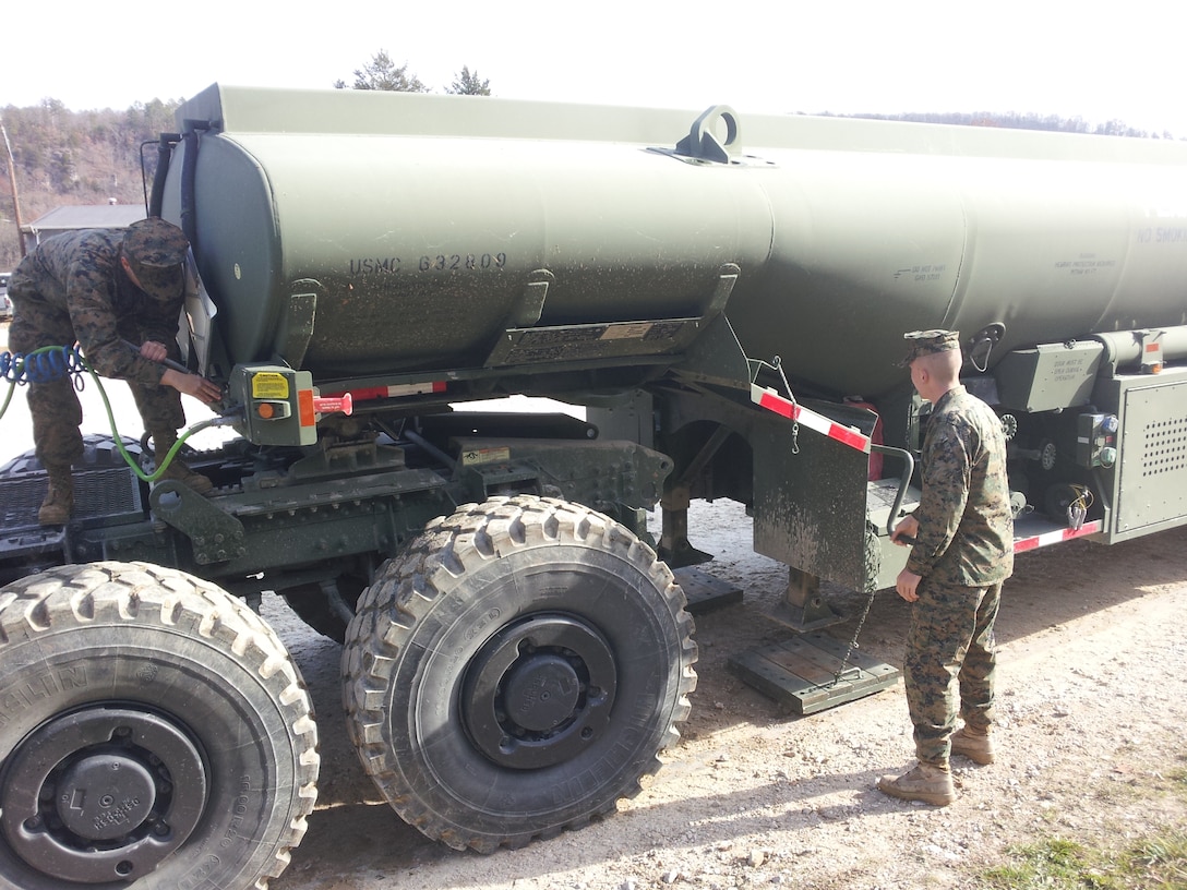 Lance Corporal Melissa L. Mueller from MWSS 271 and Lance Corporal Ryan T. Mann from CLR-2 perform Coupling and Uncoupling practical application of an AMK31 and MK970 on November 15, 2012 at Ft. Leonard Wood, MO while attending Semi-Refueler Operators Course 1-13. This is one of the first events students learn in the course prior to learning and performing tractor trailer operations and refueling operations.