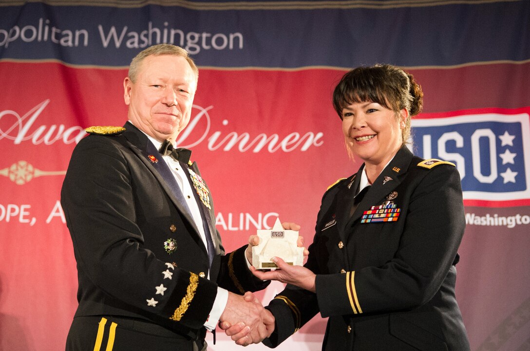 Army Gen. Frank J. Grass, left, chief of the National Guard Bureau, presents a special salute award to Army Lt. Col. Laura Wheeler, a mental health specialist serving in the National Guard, during the USO of Metropolitan Washington’s 31st awards dinner in Arlington, Va., March 14, 2013.