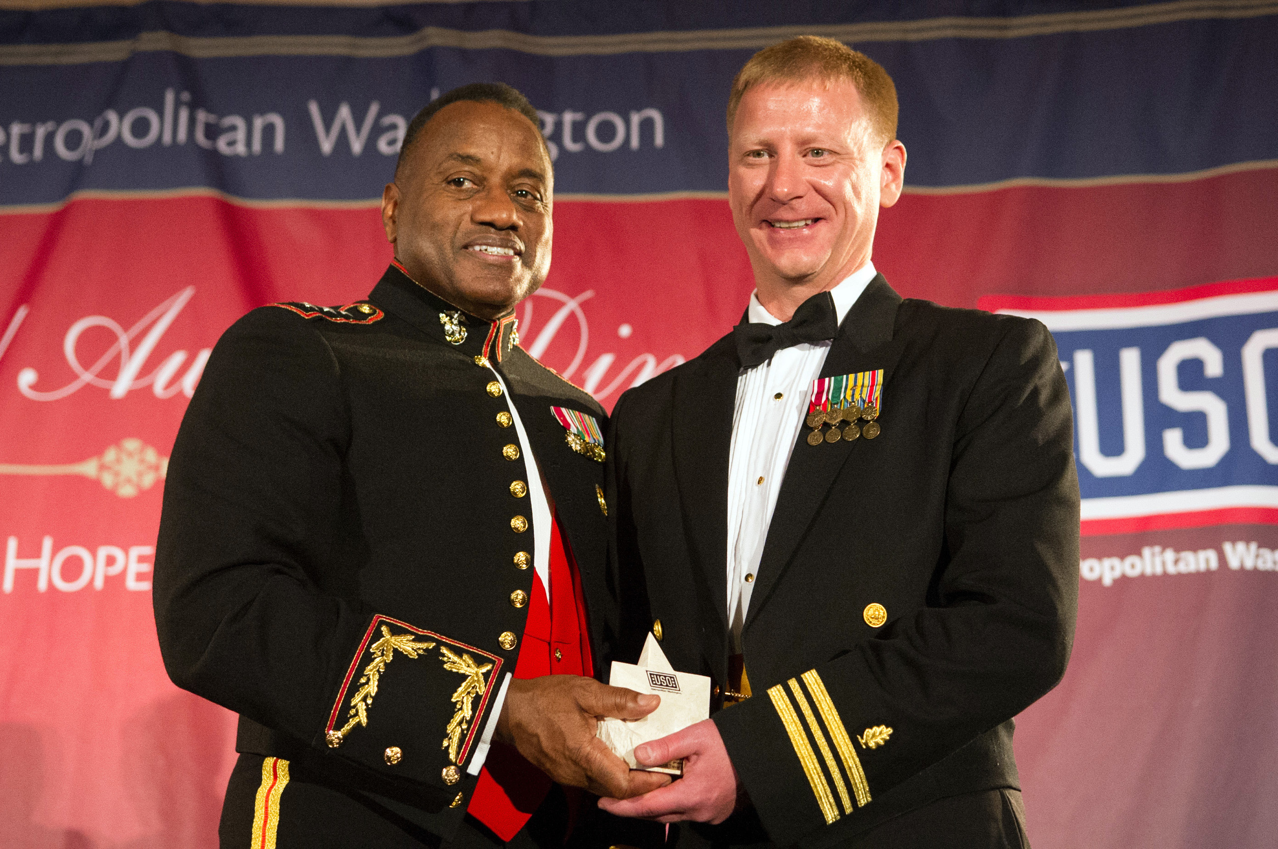 Marine Corps Lt. Gen. Willie Williams, left, director of Marine Corps  staff, presents a special salute