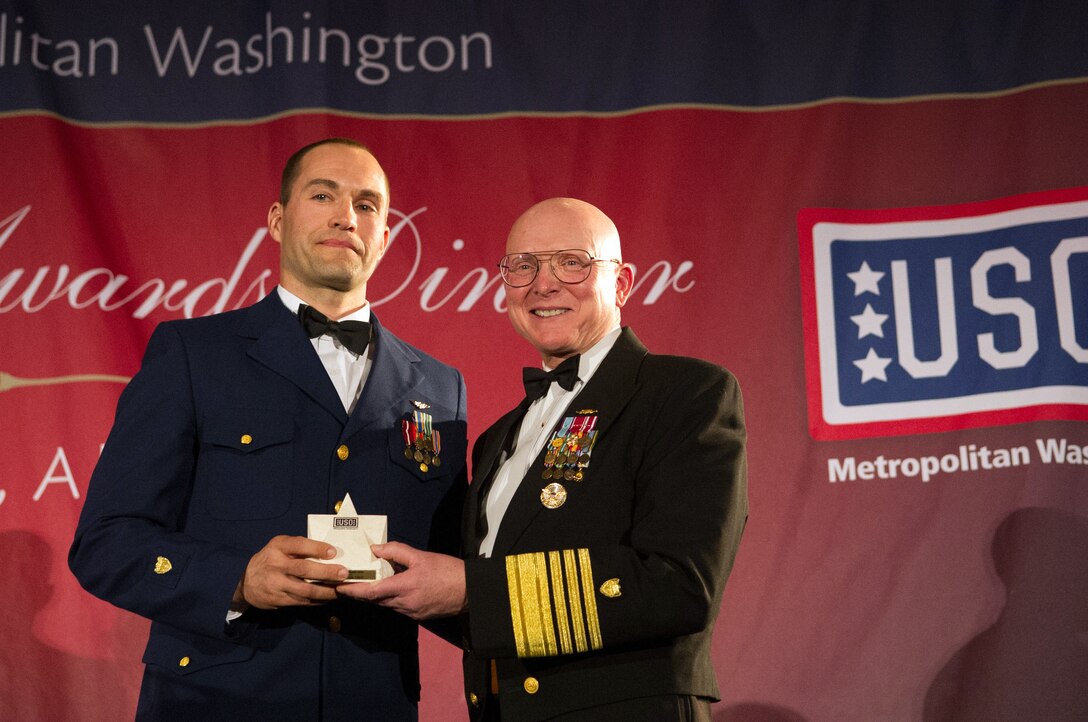 Coast Guard Commandant Adm. Robert Papp Jr., right, presents a special salute award to Navy Petty Officer 2nd Class Randy Haba during the USO of Metropolitan Washington’s 31st awards dinner in Arlington, Va., March 14, 2013. Haba is an aviation survival technician serving as a helicopter rescue swimmer in the Coast Guard.