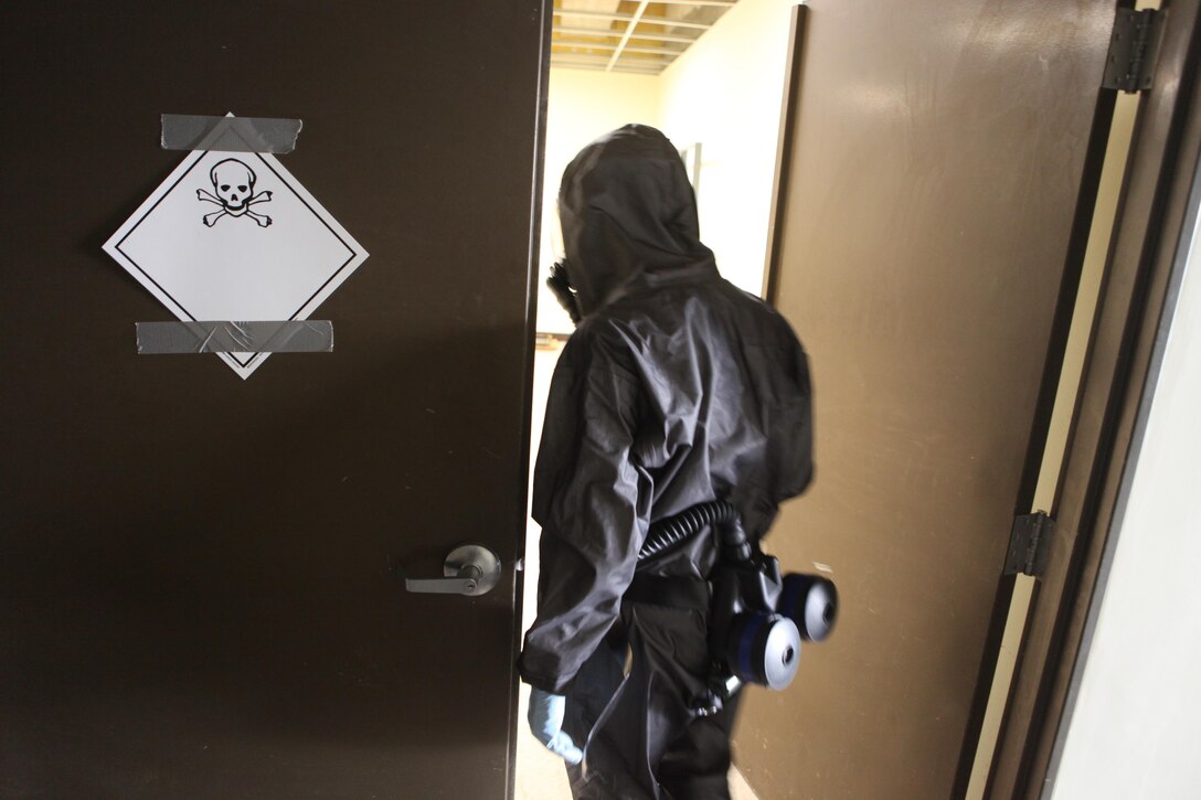 Lance Cpl. Kyle Martin, a Chemical, Biological, Radiological and Nuclear defense specialist with the Marine Air Ground Task Force Assessment and Consequence Management Team of the 31st Marine Expeditionary Unit and a native of Fall River, Mass., enters a room containing chemical weapon-making materials in a warehouse here, March 14. The CBRN operation was in response to the confirmed presence of a chemical weapon-making facility during a notional humanitarian aid and disaster relief operation. The MAGTF ACMT evacuated casualties, inspected the premises and removed all chemical materials found. The 31st MEU’s CERTEX is a semiannual exercise where Special Operations Training Group, III Marine Expeditionary Force, evaluates the unit’s full range of capabilities, with the purpose of maintaining the MEU’s proficiency and readiness. The 31st MEU is the only continuously forward-deployed MEU and is the Marine Corps’ force in readiness in the Asia-Pacific region.