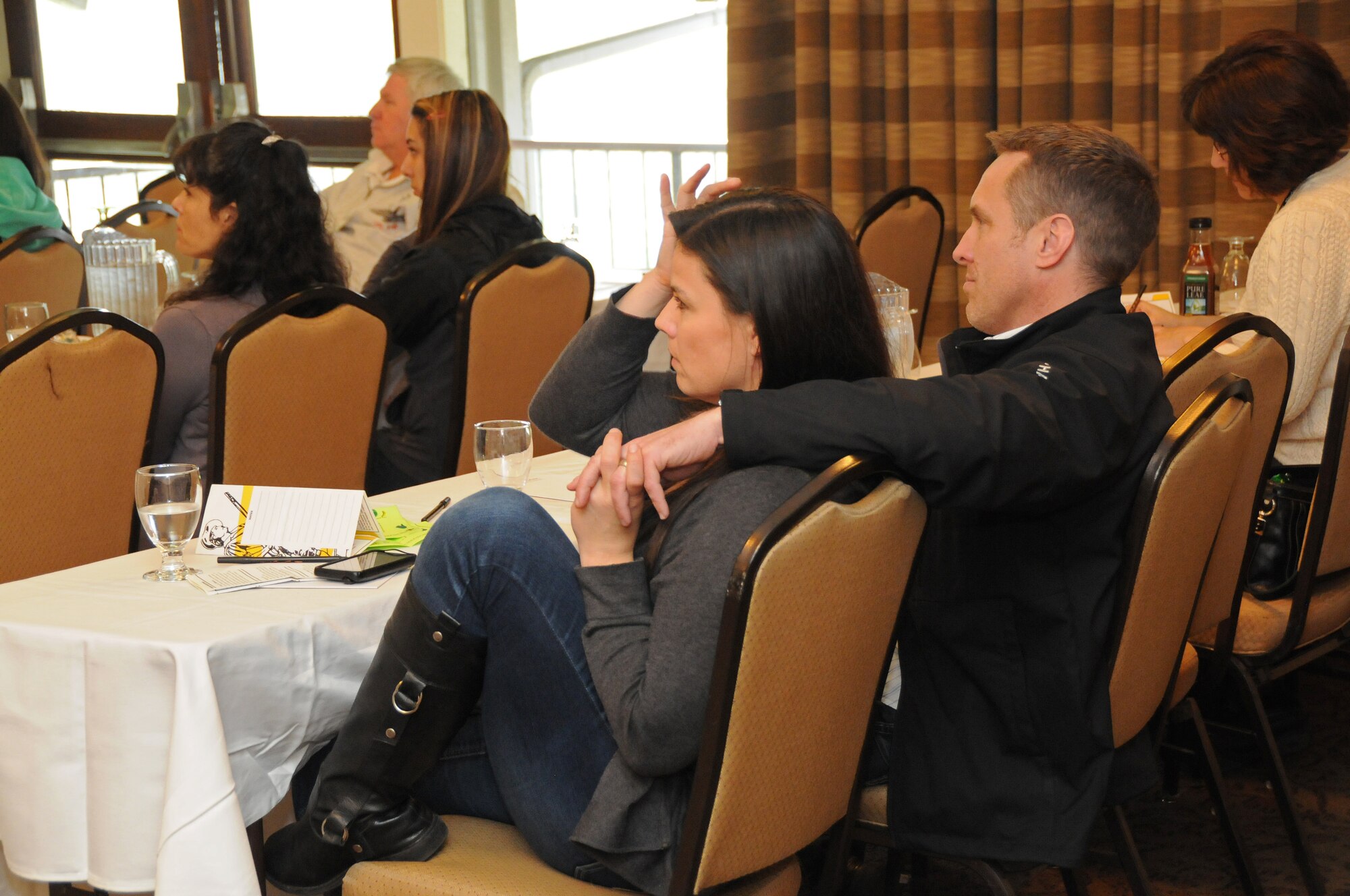 Lt. Col. Alaric Michaelis, a pilot for the 173rd Fighter Wing and his wife listen to a briefing on reintegration during the Yellow Ribbon reintegration event at the Salishan Lodge in Gleneden Beach, Ore.  Michaelis recently returned from a deployment to Al Dhafra, in the United Arab Emirates. (U.S. Air Force photo by Tech. Sgt. Jefferson Thompson) RELEASED
