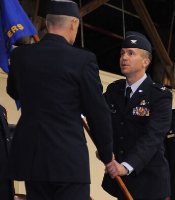 Colonel Jeremy Baenen, incomming commander for the 173rd Fighter Wing, accepts the Wing guideon from Brig. General Steven Gregg, Commander Oregon Air National Guard, during an official change of command ceremony January 13, 2013 at Kingsley Field.  (U.S. Air Force photo by Master Sgt. Jennifer Shirar) RELEASED