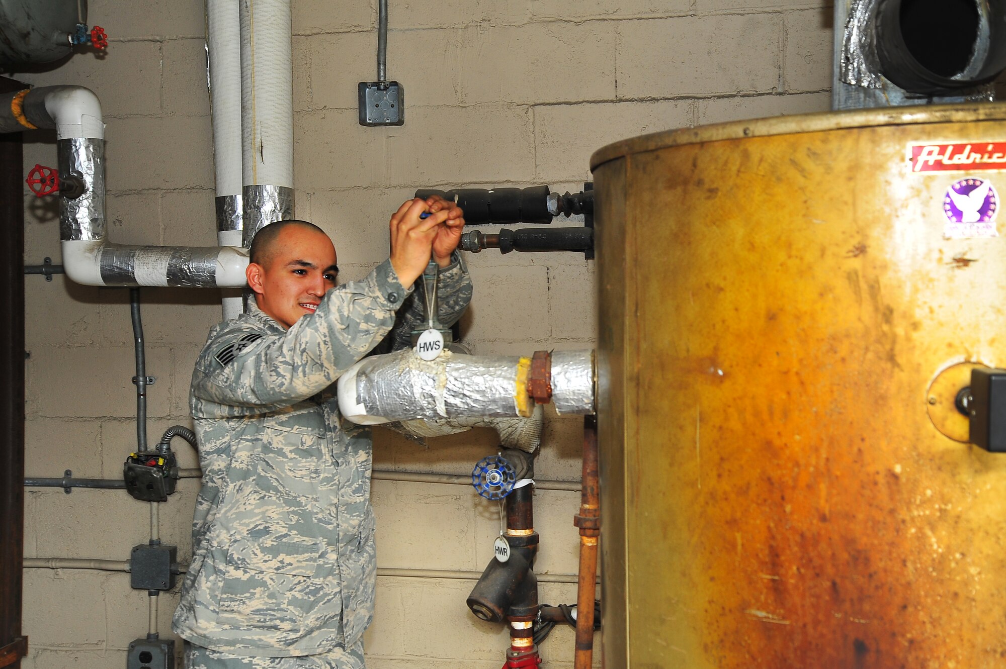 Staff Sgt. Daniel Garcia, 51st Civil Engineer Squadron Heating Ventilation and Air Conditioning technician shuts off the water to the boiler in order to prepare the HVAC system for the no heat no cool season in building 803 at Osan Air Base, Republic of Korea, March 13, 2013.  This no heat no cool season, HVAC systems in bldgs. will be prepared to switch over from heating to cooling.  (U.S. Air Force photo/Staff Sgt. Emerson Nuñez)