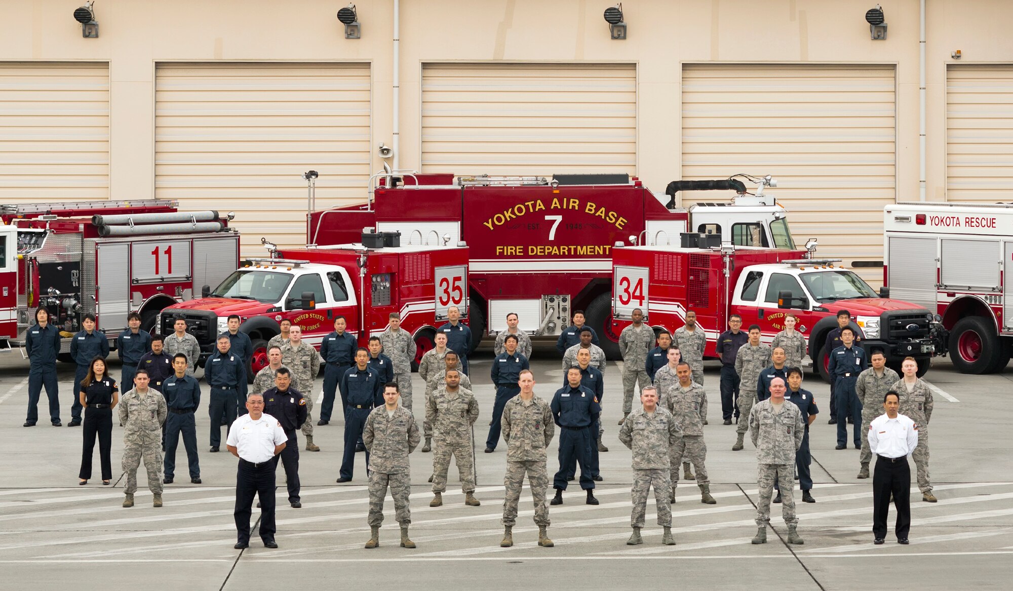 YOKOTA AIR BASE, Japan -- Members of the 374th Civil Engineer Squadron Fire Department stand tall in front of the main firehouse at Yokota Air Base, Japan,  Feb. 7, 2013. The firefighters were awarded the 2012 Best Fire Prevention Program and the Fire Department of the Year - Medium Category awards for excellent service. (U.S. Air Force photo by Osakabe Yasuo)