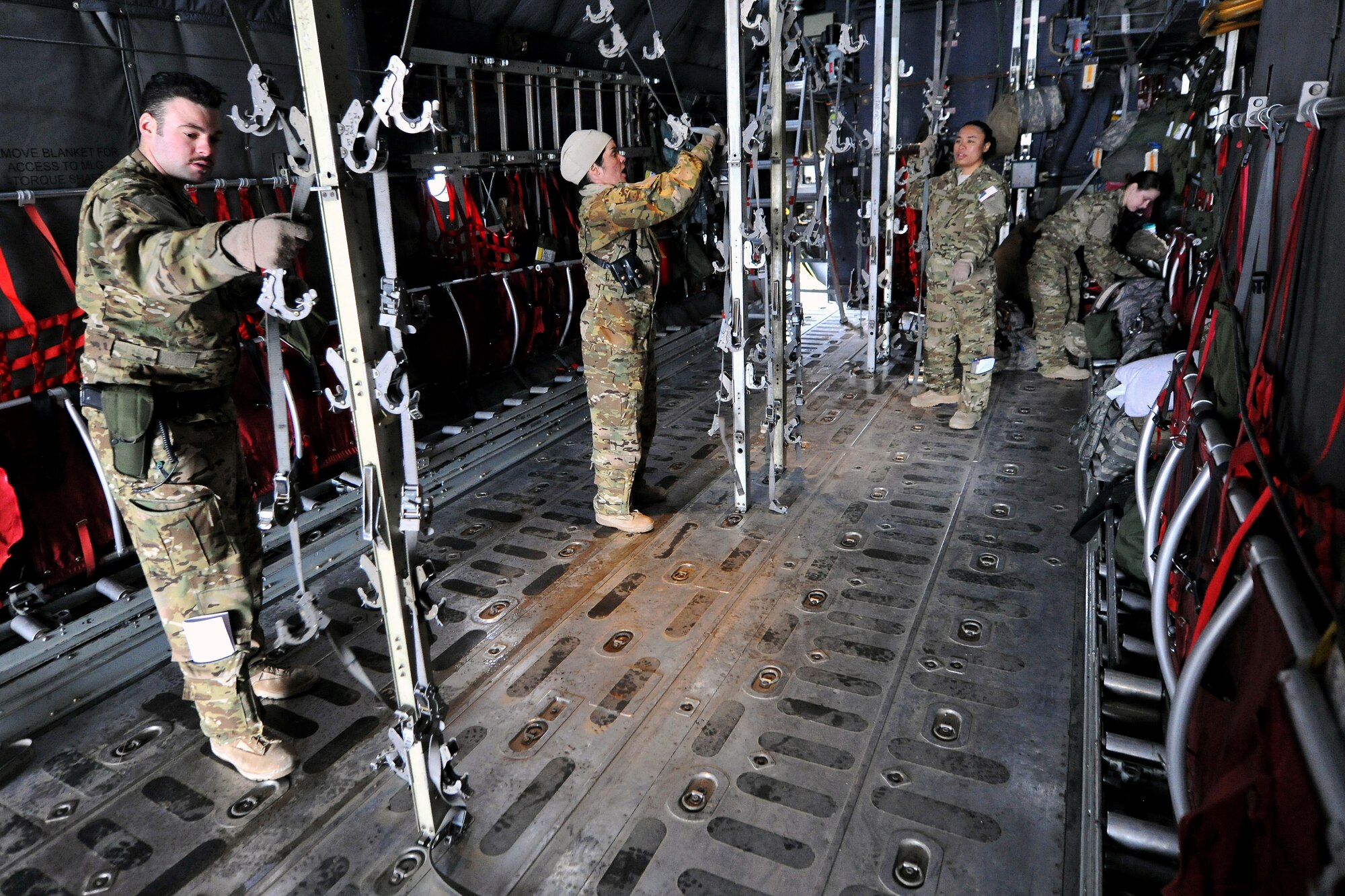 Members of the 455th Expeditionary Aeromedical Evacuation Squadron finish configuring a C-130 Hercules on Bagram Airfield, Afghanistan, Feb. 21, 2013. The 455th EAES provides medical and nursing care in flight to ill or injured servicemembers or Department of Defense civilians.  (U.S. Air Force photo/Senior Airman Chris Willis)