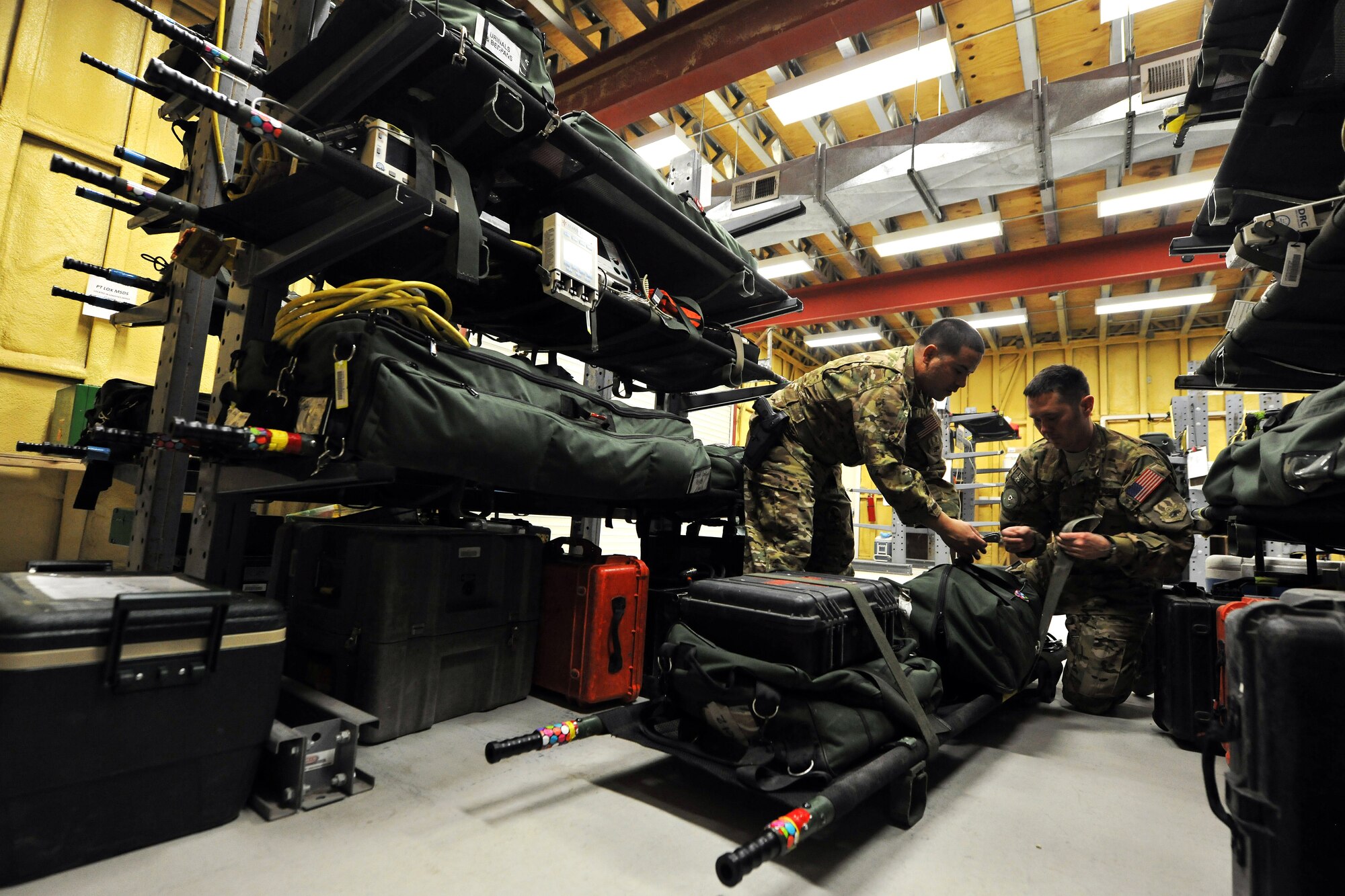 Tech. Sgt. Alejandro Rojas and Staff Sgt. Anthony Bradford, 455th Expeditionary Aeromedical Evacuation Squadron technicians, perform an equipment check before a mission on Bagram Airfield, Afghanistan, Feb. 21, 2013. The 455th EAES perform their missions on fixed wing aircraft, including the C-17 Globemaster III, C-130 Hercules and KC-135 Stratotanker, and can provide extensive critical care capability with the Critical Care Air Transport Teams. (U.S. Air Force photo/Senior Airman Chris Willis)