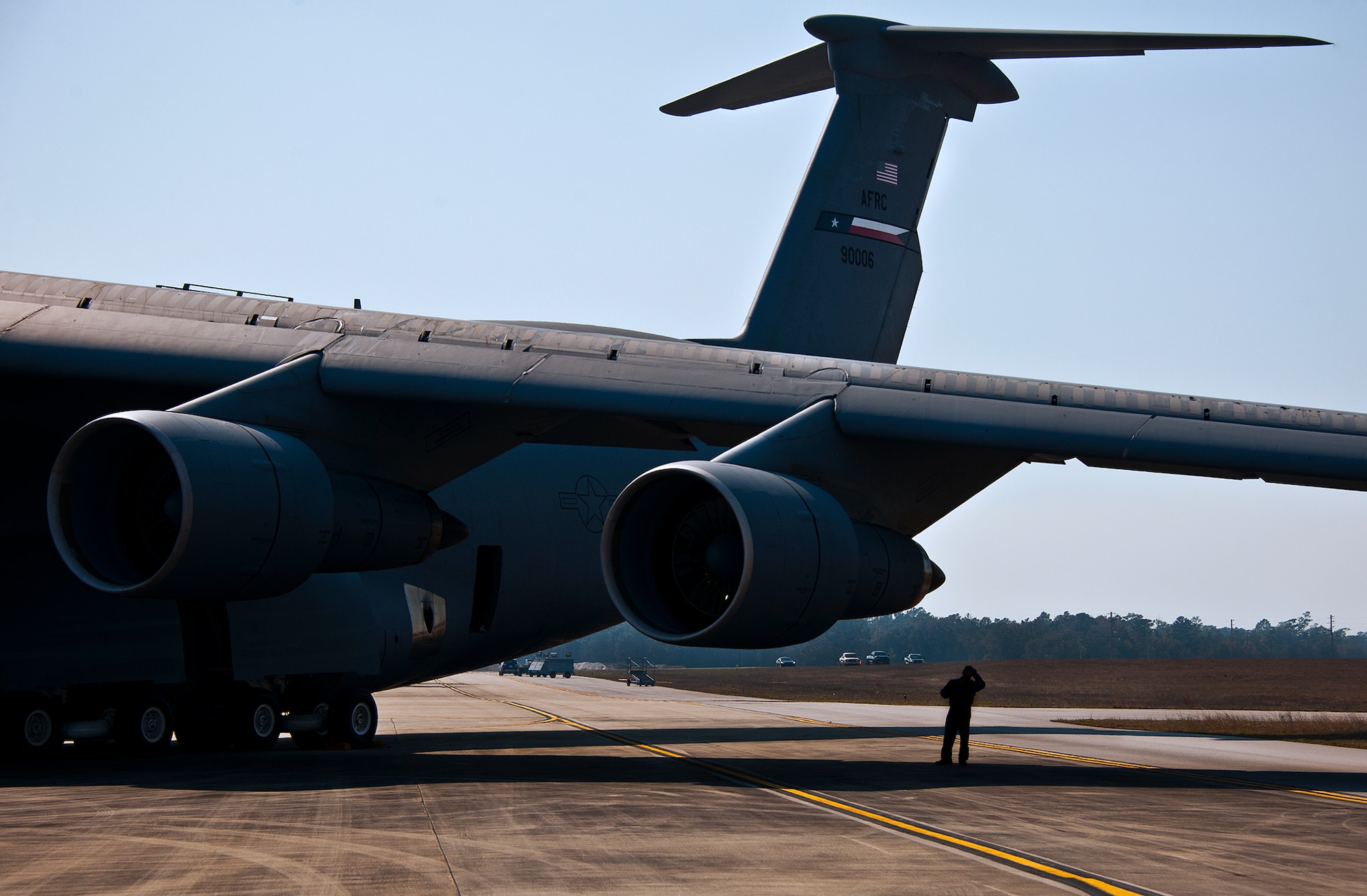 An aircrew member of the 433rd Airlift Wing performs a post-flight inspection the engine of a C-5 Galaxy after its arrival to Eglin Air Force Base, Fla., March 14.  The reserve wing’s aircraft brought maintenance equipment from the 482nd Fighter Wing to the base in preparation for the weapons system evaluation program taking place March 18-22.  (U.S. Air Force photo/Samuel King Jr.)