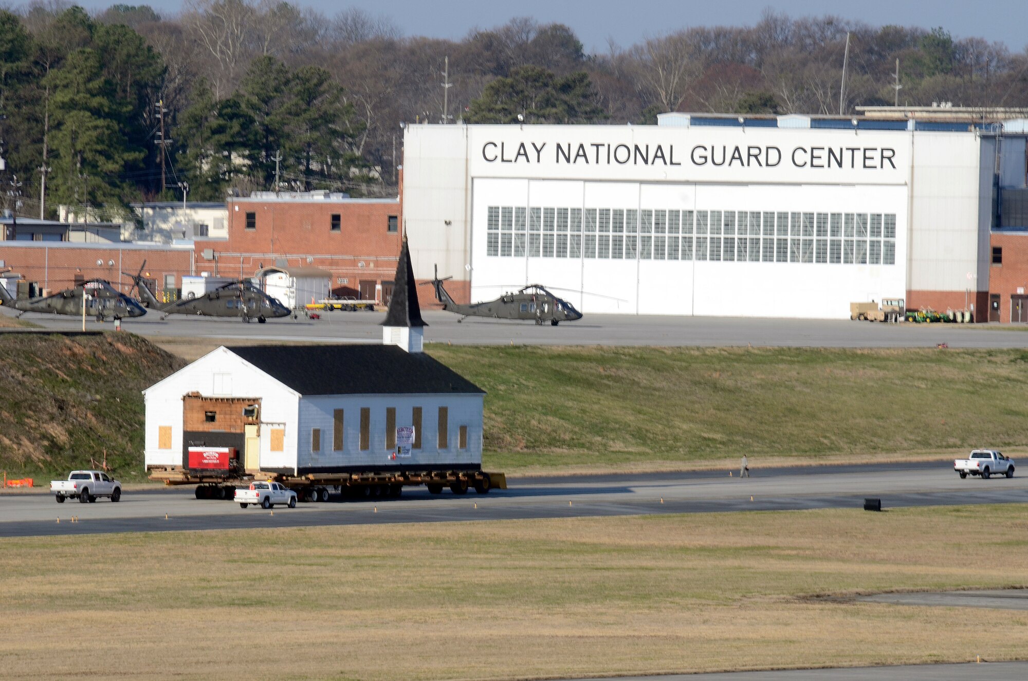 Crew members from Hercules House Movers with assistance from Brownie Moving and Heavy Hauling, Inc. move the Dobbins Air Reserve Base chapel across the base runway, two miles to Clay Army National Guard Camp, Ga. March 17. Dobbins has been home to the chapel for over 60 years and has played a large role in member’s lives both past and present. (U.S. Air Force photo/Don Peek)