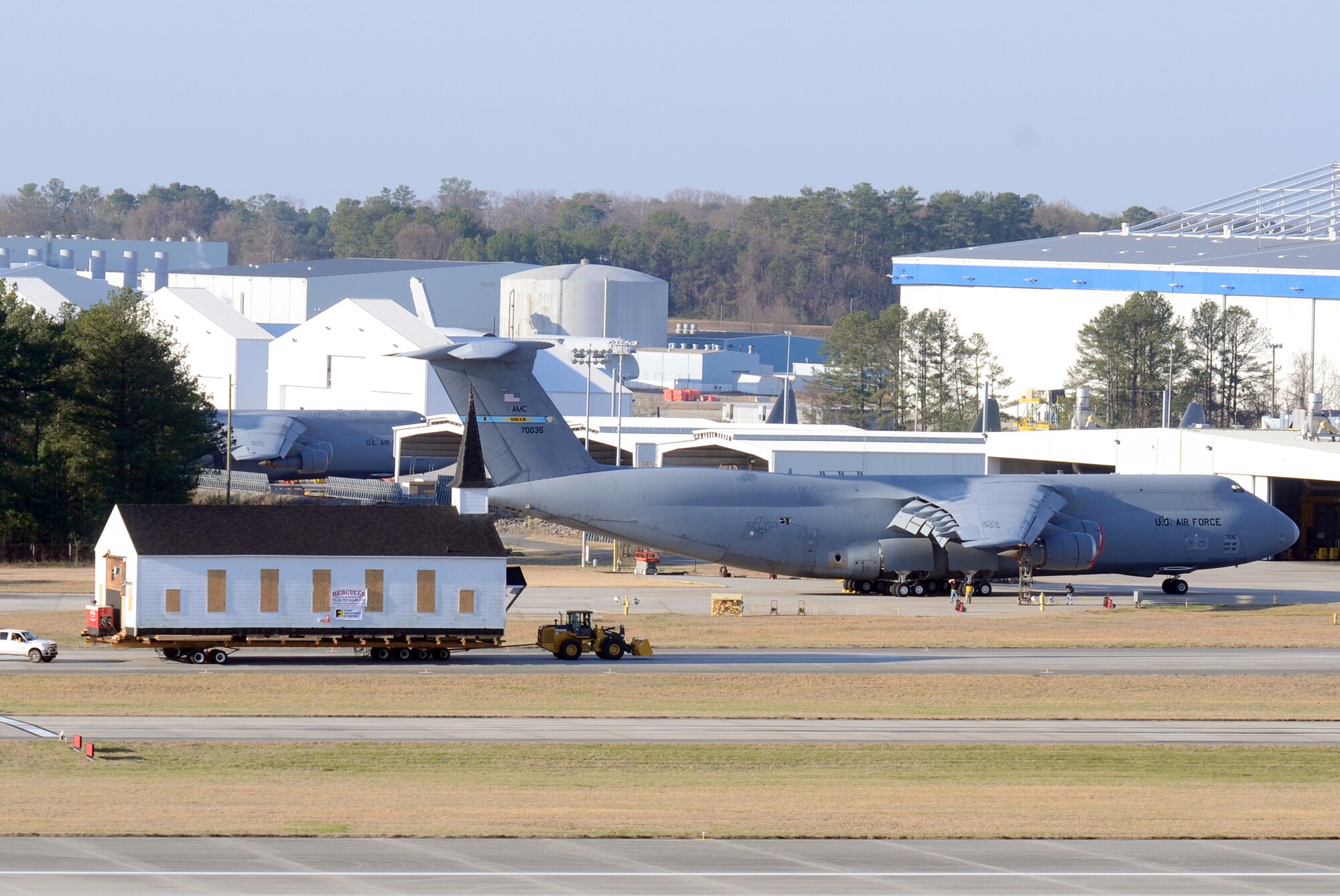 Crew members from Hercules House Movers with assistance from Brownie Moving and Heavy Hauling, Inc. move the Dobbins Air Reserve Base chapel across the base runway, two miles to Clay Army National Guard Camp, Ga. March 17. Dobbins has been home to the chapel for over 60 years and has played a large role in member’s lives both past and present. (U.S. Air Force photo/Don Peek)