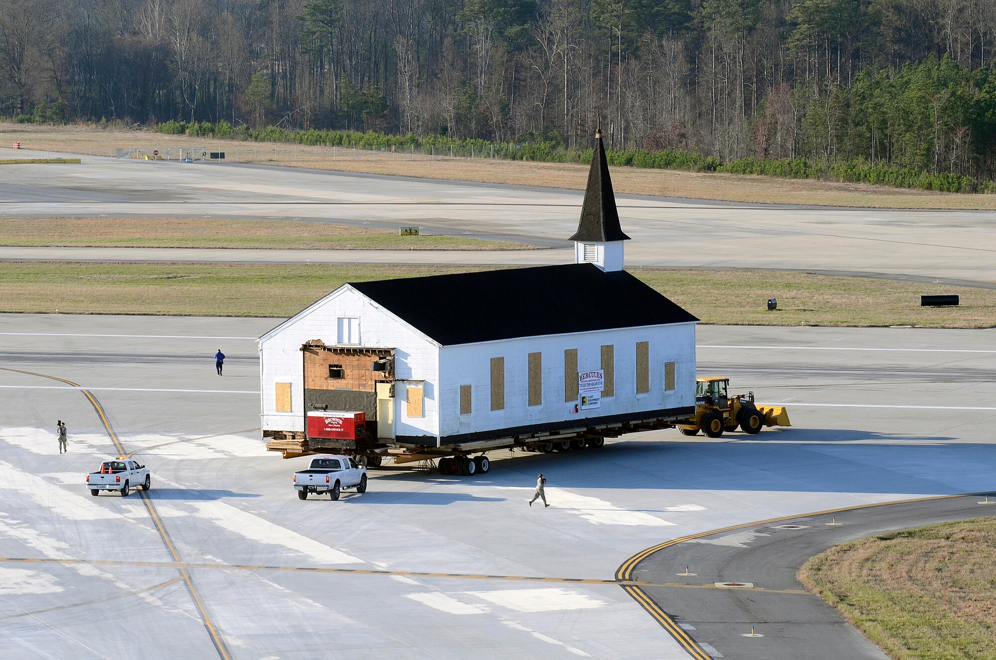 Crew members from Hercules House Movers with assistance from Brownie Moving and Heavy Hauling, Inc. move the Dobbins Air Reserve Base chapel across the base runway, two miles to Clay Army National Guard Camp, Ga., March 17. Dobbins has been home to the chapel for over 60 years and has played a large role in member’s lives both past and present. (U.S. Air Force photo/Don Peek)