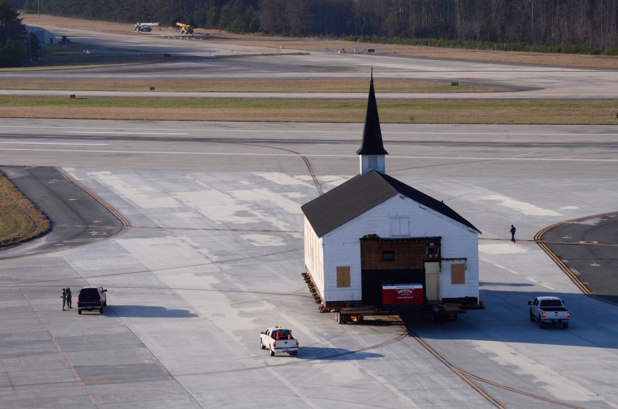 Crew members from Hercules House Movers with assistance from Brownie Moving and Heavy Hauling, Inc. move the Dobbins Air Reserve Base chapel across the base runway, two miles to Clay Army National Guard Camp, Ga., March 17. Dobbins has been home to the chapel for over 60 years and has played a large role in member’s lives both past and present. (U.S. Air Force photo/Don Peek)