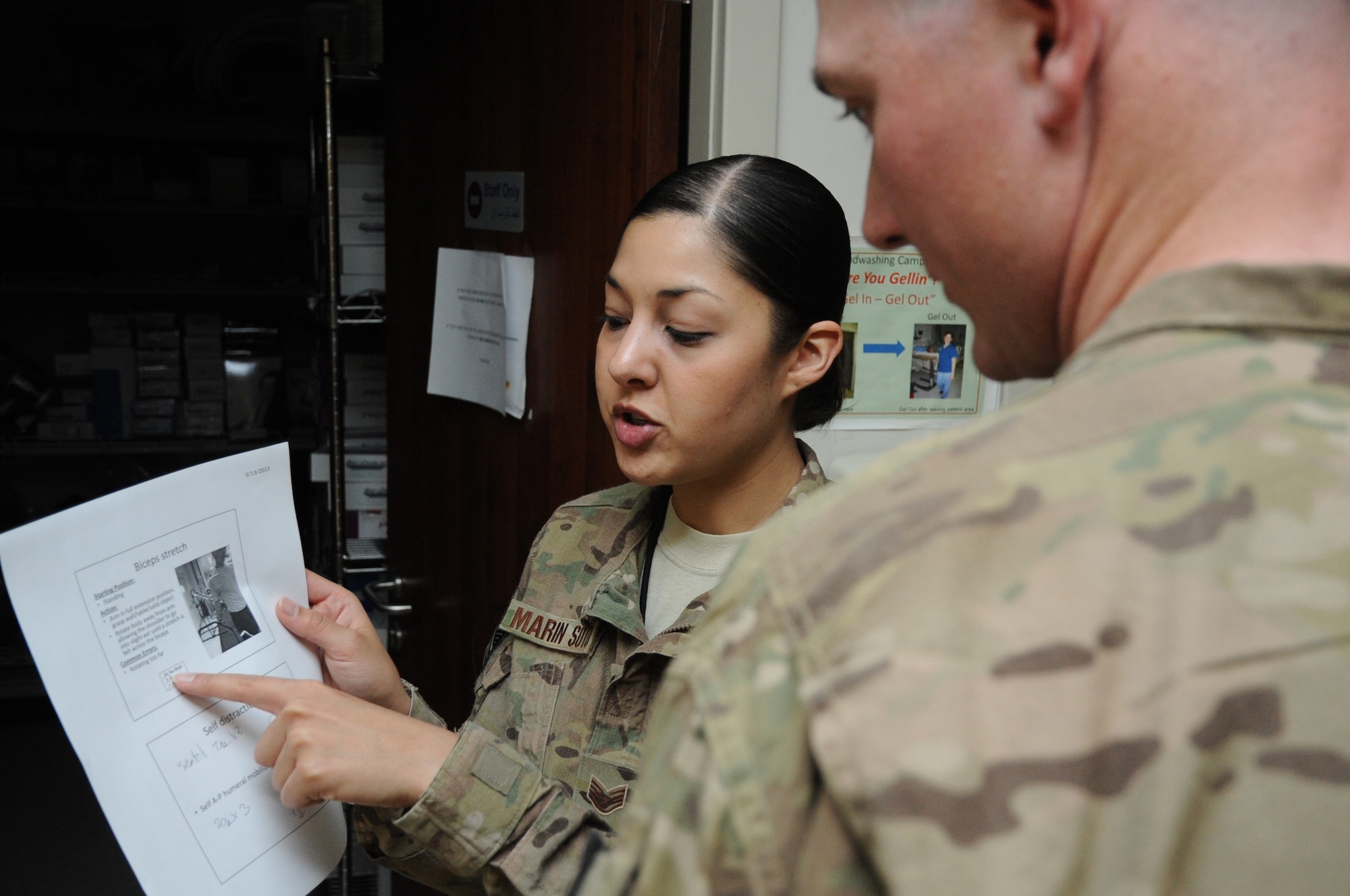 Staff Sgt. Carolina Marin Soto, 455th Expeditionary Medical Operations Squadron physical therapy NCO in charge, explains muscle exercises to a patient at the Craig Joint Theater Hospital on Bagram Airfield, Afghanistan, March 13, 2013. The Physical Therapy clinic treats approximately 350 patients each month, including servicemembers and local nationals. (U.S. Air Force photo/Staff Sgt. David Dobrydney)