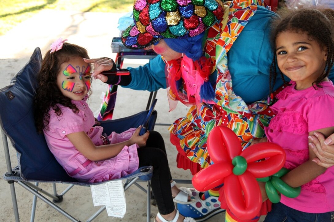 Sophia Gilcardona, daughter of 2nd Lt. Cesar Gilcardona, a supply officer with Combat Logistics Regiment 15, 1st Marine Logistics Group and a native of Queens, N.Y., gets her face painted during the units family day event, Friday, March 15, 2013, aboard Camp Pendleton, Calif. Families enjoyed activities such as a pie eating competition, rock climbing, balloon darts, and jungle gyms throughout the day. 