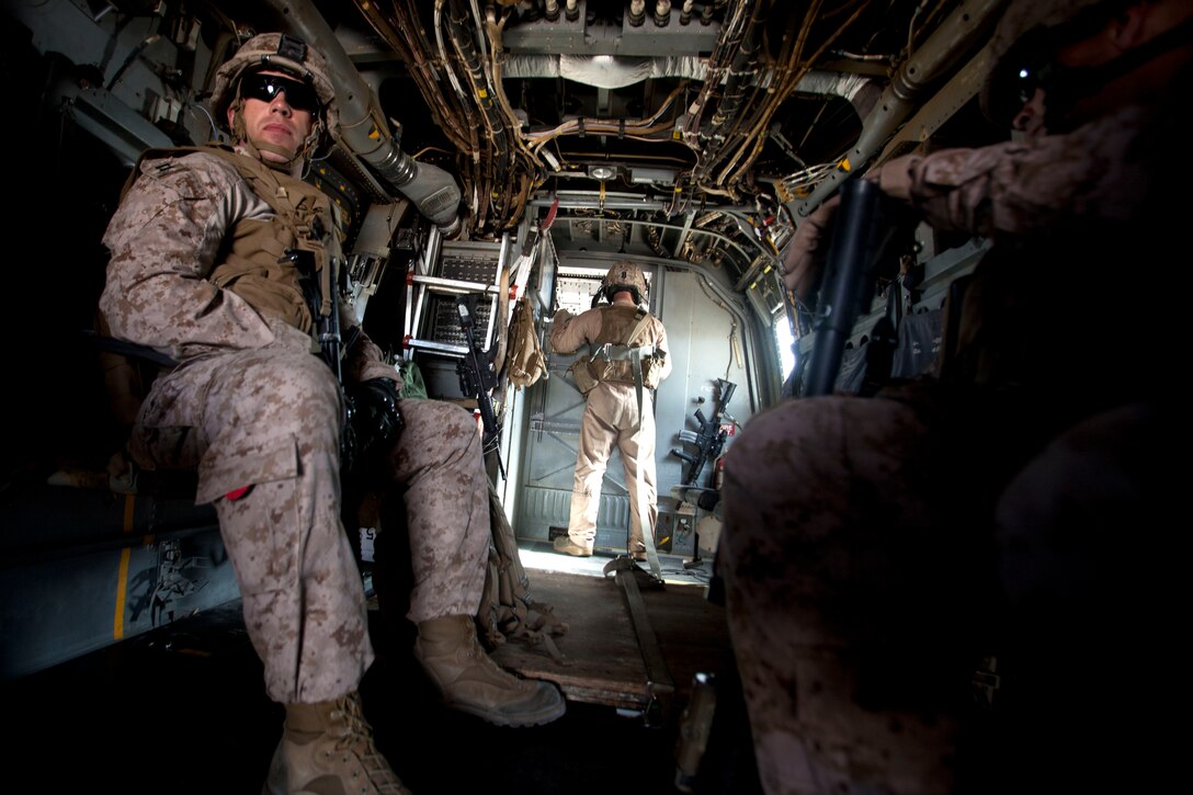 U.S. Marine Capt. Matthew A. Krempel, left, rides on a MV-22 Osprey helicopter to Camp Dwyer, Helmand Province, Afghanistan, March 16, 2013. Brig. Gen. Smith, the deputy commander of Regional Command (Southwest), visited the security force advisor team to attend their operations meeting and view the progress of Afghan National Army's 1st Brigade headquarters buildings. (U.S. Marine Corps photo by Staff Sgt. Neill A. Sevelius/Released)