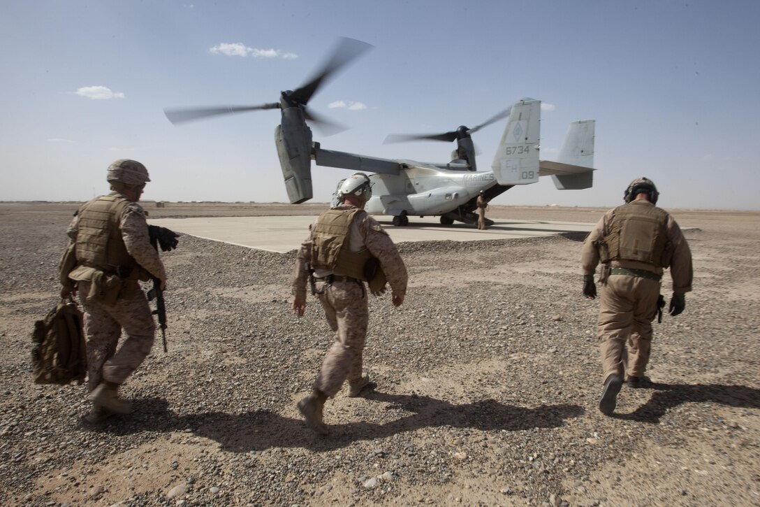 U.S. Marines prepare to board an MV-22 Osprey helicopter after visiting the new developments aboard Camp Dwyer, Helmand Province, Afghanistan, March 16, 2013. Brig. Gen. Smith, the deputy commander of Regional Command (Southwest), visited the security force advisor team to attend their operations meeting and view the progress of Afghan National Army's 1st Brigade headquarters buildings. (U.S. Marine Corps photo by Staff Sgt. Neill A. Sevelius/Released)