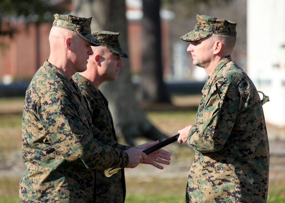 Marine Corps Base Camp Lejeune, N.C. Sgt. Maj. Carl Chapman, left, outgoing sergeant major of the 22nd Marine Expeditionary Unit, relinquishes the non-commissioned officer sword during the relief and appointment of the 22nd MEU sergeant major aboard Marine Corps Base Camp Lejeune, N.C., March 7, 2013. Chapman will be retiring in June 2013 after 30 years of service. (Marine Corps photo by Lance Cpl. Caleb McDonald/Released)