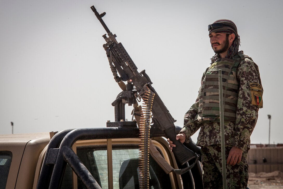 An Afghan National Army soldier with the 215th Corps, Engineer Kandak provides security for his counterparts during a clearing operation near Camp Shorabak, Helmand Province, Afghanistan, March 16, 2013.  The operation was designed to eliminate possible enemy firing positions in preparation for the upcoming fighting season. (U.S. Marine Corps photo by Staff Sgt. Ezekiel R. Kitandwe/Released)