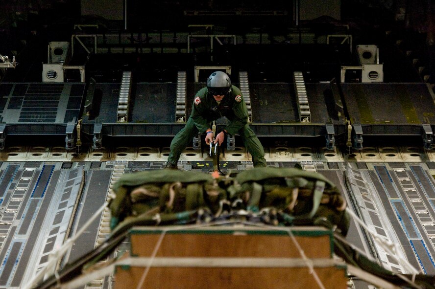 Senior Airman Kelly Bollinger, a C-17 Globemaster III loadmaster, readies heavy cargo for an airdrop mission during Cope Tiger 13 at Udon Thani Royal Thai Air Force Base, Thailand, March 15, 2013. Bollinger is assigned to the 517th Airlift Squadron, Joint Base Elmendorf-Richardson, Alaska. More than 300 U.S. service members are participating in CT13, which offers an unparalleled opportunity to conduct a wide spectrum of large force employment air operations and strengthen military-to-military ties with two key partner nations, Thailand and Singapore. (U.S. Air Force photo/2nd Lt. Jake Bailey)
