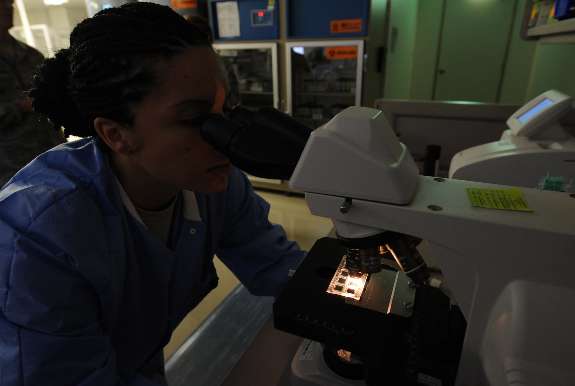 U.S. Air Force Senior Airman Taniah Otis, 18th Medical Support Squadron section supervisor of shipping and hematology, looks through a urinalysis microscope on Kadena Air Base, Japan, March 14, 2013. Otis analyzes specimens for diagnostics testing to check for various bacteria found in the urine sample of patients. (U.S. Air Force photo/Airman 1st Class Keith A. James)