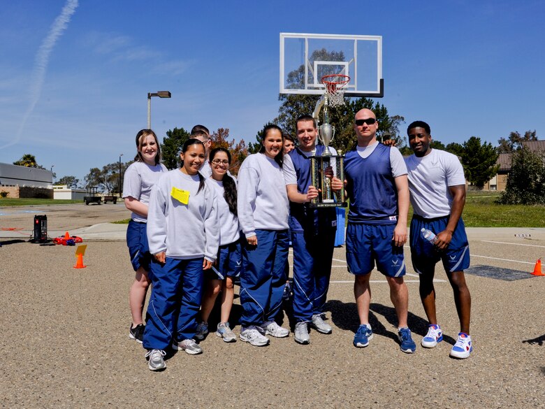VANDENBERG AIR FORCE BASE, Calif. – Unit winners of the March Madness shootout pose with their trophy at the Pacific Coast Club parking lot here Friday, March 15, 2013. Wingman Day events gave more than 4,000 Team V members the opportunity to interact with one another and to learn about different topics such as branding yourself and interpersonal relationships. (U.S. Air Force photo/Airman Yvonne Morales)