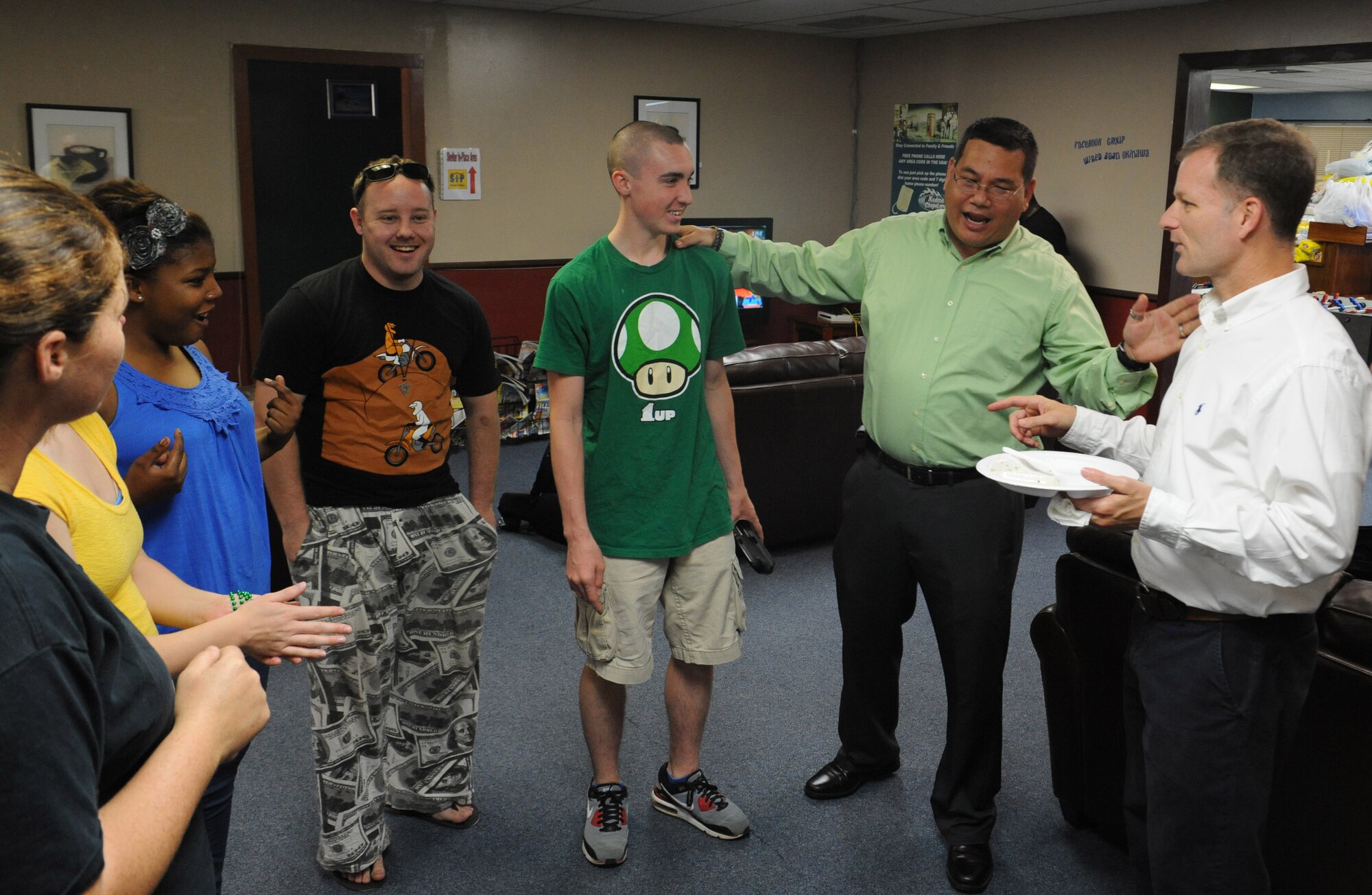 U.S. Air Force Chaplain (Capt.) Craig Nakagawa, an 18th Wing Protestant chaplain, introduces Airmen to Chaplain (Col.) Dondi Costin, Pacific Air Forces command chaplain, at the Wired Bean on Kadena Air Base, Japan, March 17, 2013. During his visit to Kadena, Costin checked the chapel's facilities to acquire the needs, wants and concerns of the Airmen. (U.S. Air Force photo/Airman 1st Class Malia Jenkins)