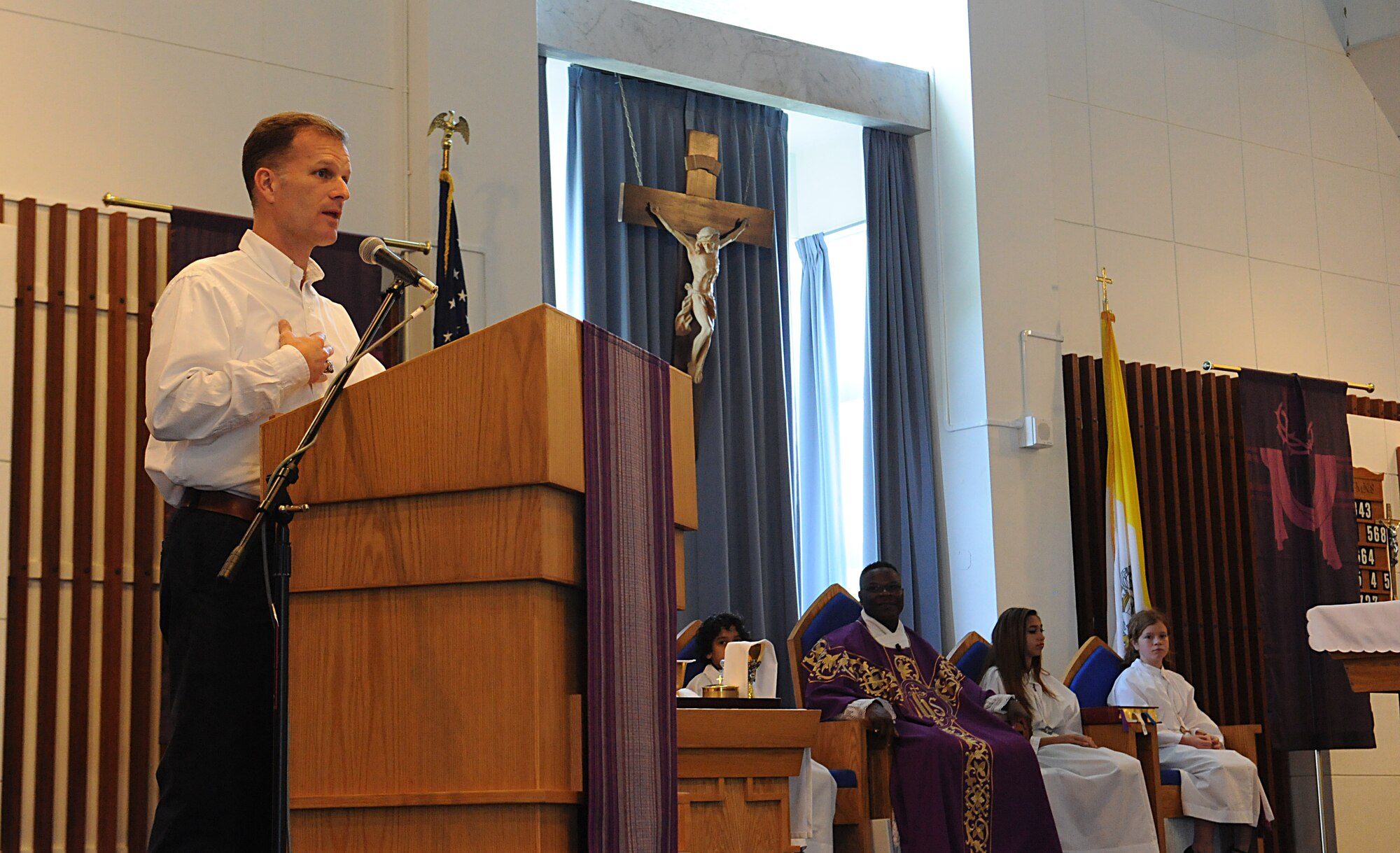 U.S. Air Force Chaplain (Col.) Dondi Costin, Pacific Air Forces command chaplain, greets Kadena service members and their families during Catholic mass on Kadena Air Base, Japan, March 17, 2013. Costin develops theater-specific policies and procedures, establishes chaplain corps manpower requirements, and provides functional oversight to chaplain corps personnel at nine locations supporting 45,000 Airmen and families. (U.S. Air Force photo/Airman 1st Class Malia Jenkins)