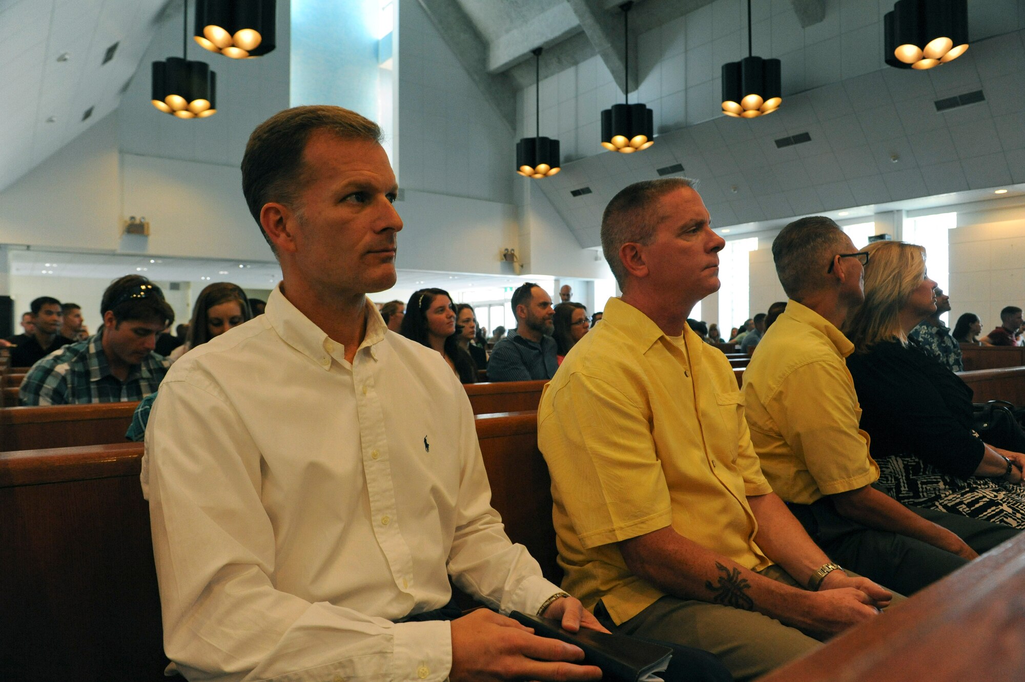 U.S. Air Force Chaplain (Col.) Dondi Costin, Pacific Air Forces command chaplain, and Chief Master Sgt. Douglas Onwiler, PACAF chaplain assistant functional manager, listen to a sermon on Kadena Air Base, Japan, March 17, 2013. Costin visited Kadena to check the chapel's facilities and acquire the needs, wants and concerns of the Airmen. (U.S. Air Force photo/Airman 1st Class Malia Jenkins)