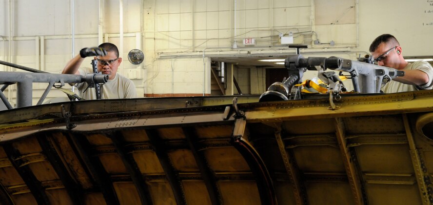 Staff Sgts. Steven Gutierrez and Jason Bliffen, both from the 2nd Maintenance Squadron Aircraft Structural Maintenance, secure an upper body cowling to a trailer on Barksdale Air Force Base, La., March 18. The aircraft structural maintenance section has the responsibility of maintaining the structural integrity of the B-52H Stratofortress by removing corrosion, repairing cowlings and repainting the skin. (U.S. Air Force photo/Airman 1st Class Andrew Moua)