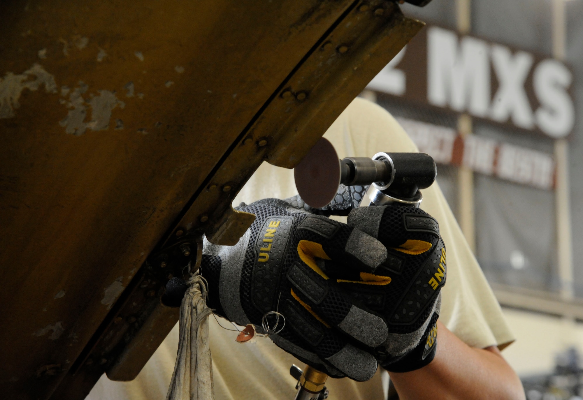 Staff Sgt. Steven Gutierrez, 2nd Maintenance Squadron Aircraft Structural Maintenance, sands a nacelle strut trailing edge on Barksdale Air Force Base, La., March 18. Also known as a "sailboat" due to its shape, and is one of many pieces attached to a B-52H Stratofortress' engine to form an engine cowling. (U.S. Air Force photo/Airman 1st Class Andrew Moua)
