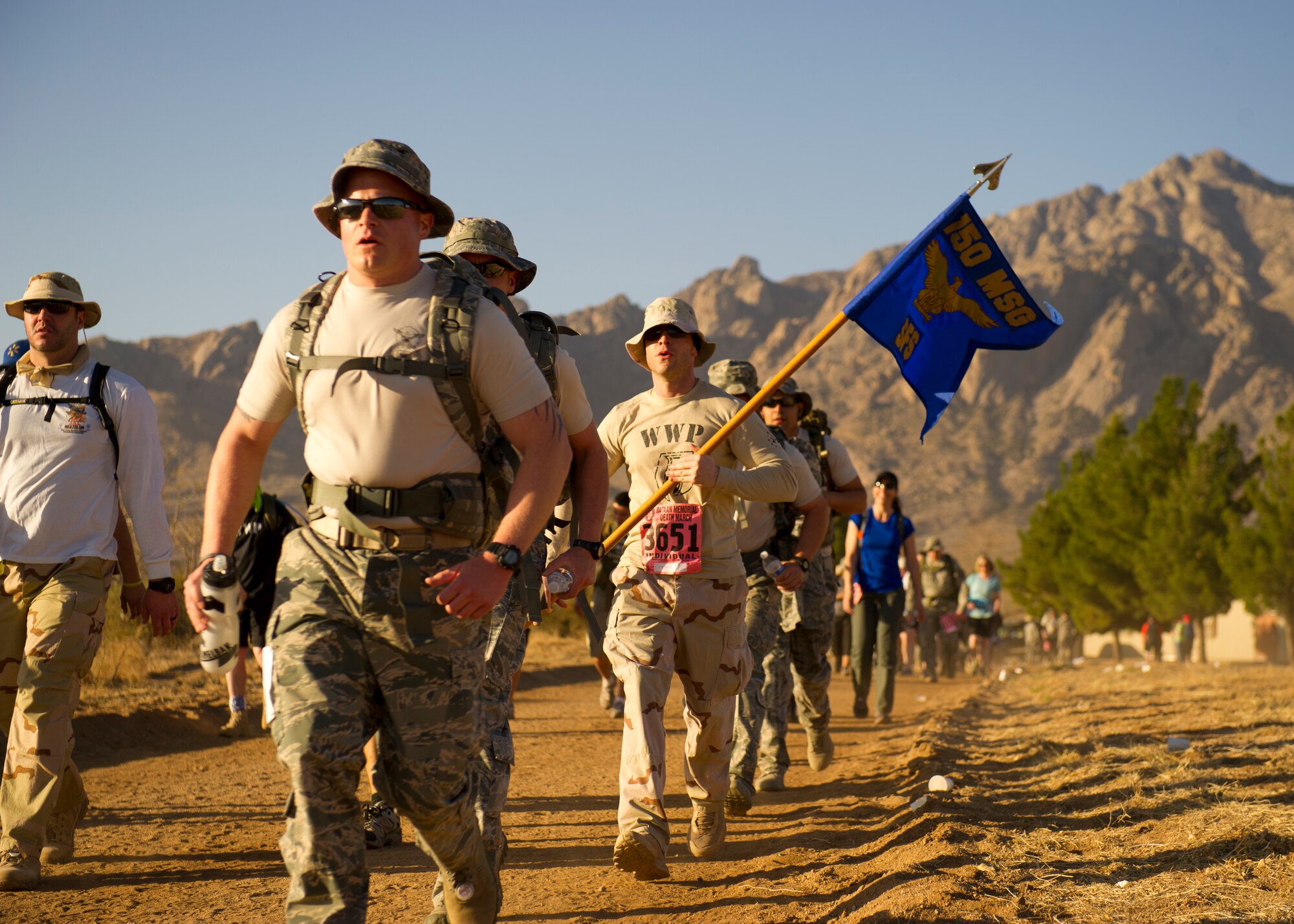 Participants in the Bataan Memorial Death March begin their trek through the sand at White Sands Missile Range, N.M., March 17. The event included both a full 26.2-mile marathon and a 15.2-mile honorary march. More than 5,800 people from across the world participated in the 26.2-mile memorial march to honor the 76,000 prisoners of war who were forced to endure marching nearly 80 miles under brutal conditions during World War II. (U.S. Air Force Photo by Airman 1st Class Michael Shoemaker/Released)