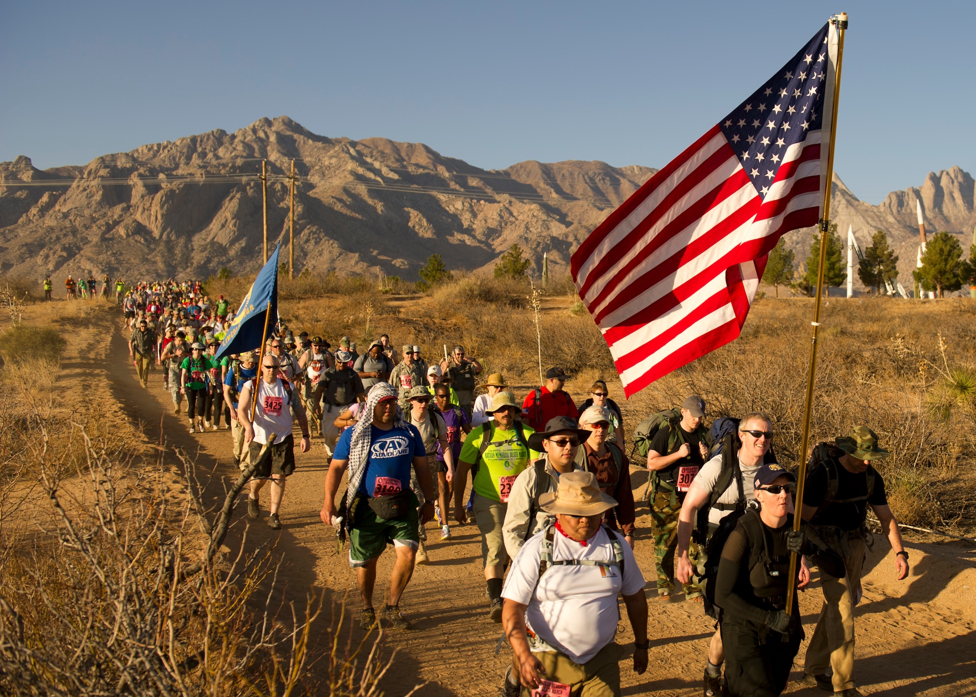 Participants in the Bataan Memorial Death March begin their trek through the sand at White Sands Missile Range, N.M., March 17. The event included both a full 26.2-mile marathon and a 15.2-mile honorary march. More than 5,800 people from across the world participated in the 26.2-mile memorial march to honor the 76,000 prisoners of war who were forced to endure marching nearly 80 miles under brutal conditions during World War II. (U.S. Air Force Photo by Airman 1st Class Michael Shoemaker/Released)
