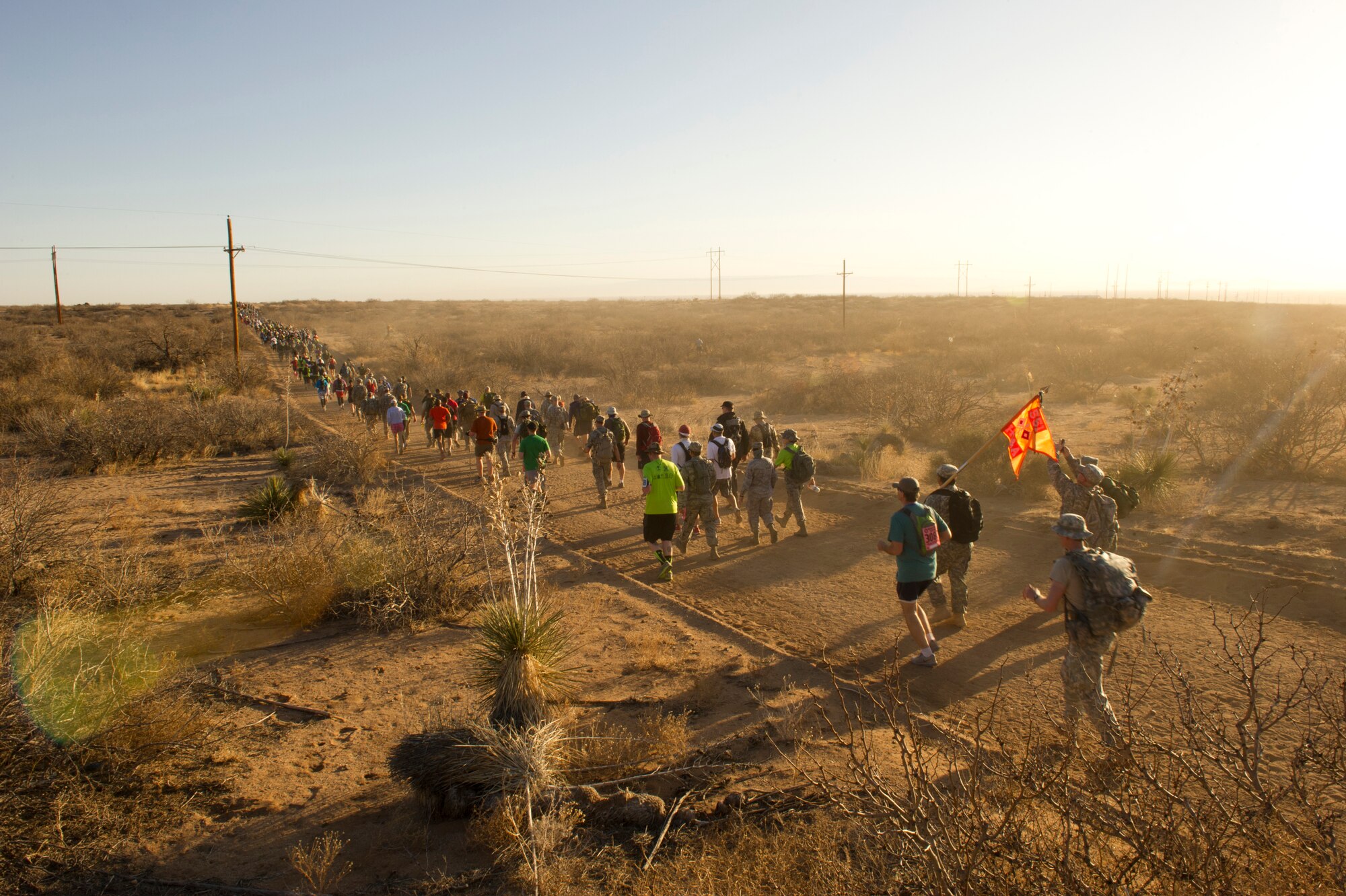 Participants in the Bataan Memorial Death March begin their trek through the sand at White Sands Missile Range, N.M., March 17. The event included both a full 26.2-mile marathon and a 15.2-mile honorary march. More than 5,800 people from across the world participated in the 26.2-mile memorial march to honor the 76,000 prisoners of war who were forced to endure marching nearly 80 miles under brutal conditions during World War II. (U.S. Air Force Photo by Airman 1st Class Michael Shoemaker/Released)