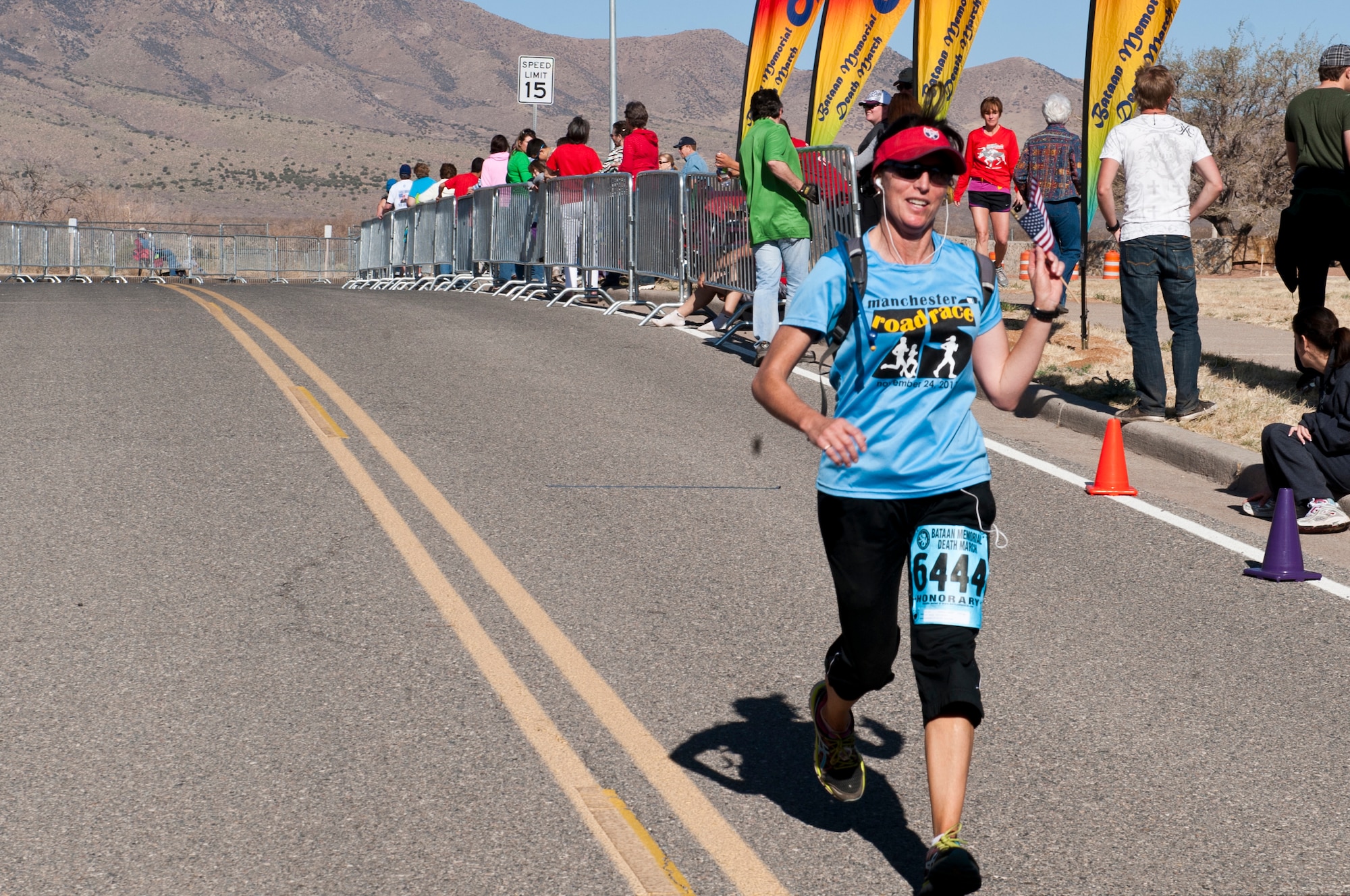 A participant in the 24th Annual Bataan Memorial Death March crosses the finish line at White Sands Missile Range, N.M., March 17. More than 5,800 people who were from across the world participated in the 26.2-milememorial marathon to honor the 76,000 prisoners of war forced to endure marching nearly 80 miles under brutal conditions during World War II. The event included both a full 26.2-mile marathon and a 15.2-mile honorary march. (U.S.  Air Force photo by Airman 1st Class Daniel E. Liddicoet/Released)

