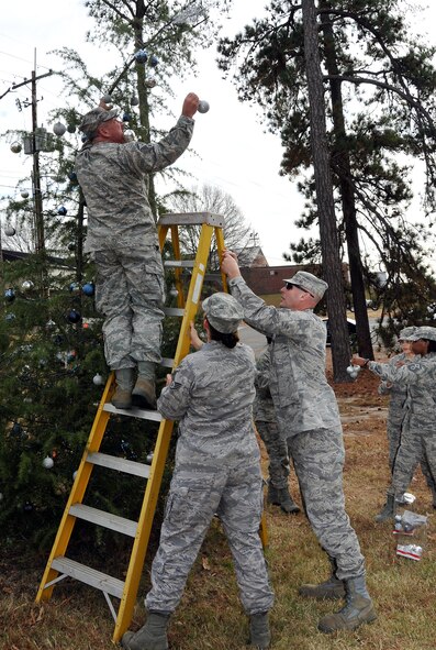 Members of the First Four, on behalf of Chief Master Sgt. Wendell Peacock, 94th Airlift Wing command chief, invited Dobbins Air Reserve Base personnel out to decorate the base holiday tree near the front gate, Nov. 30.(U.S. Air Force photo/Senior Airman Elizabeth Van Patten)